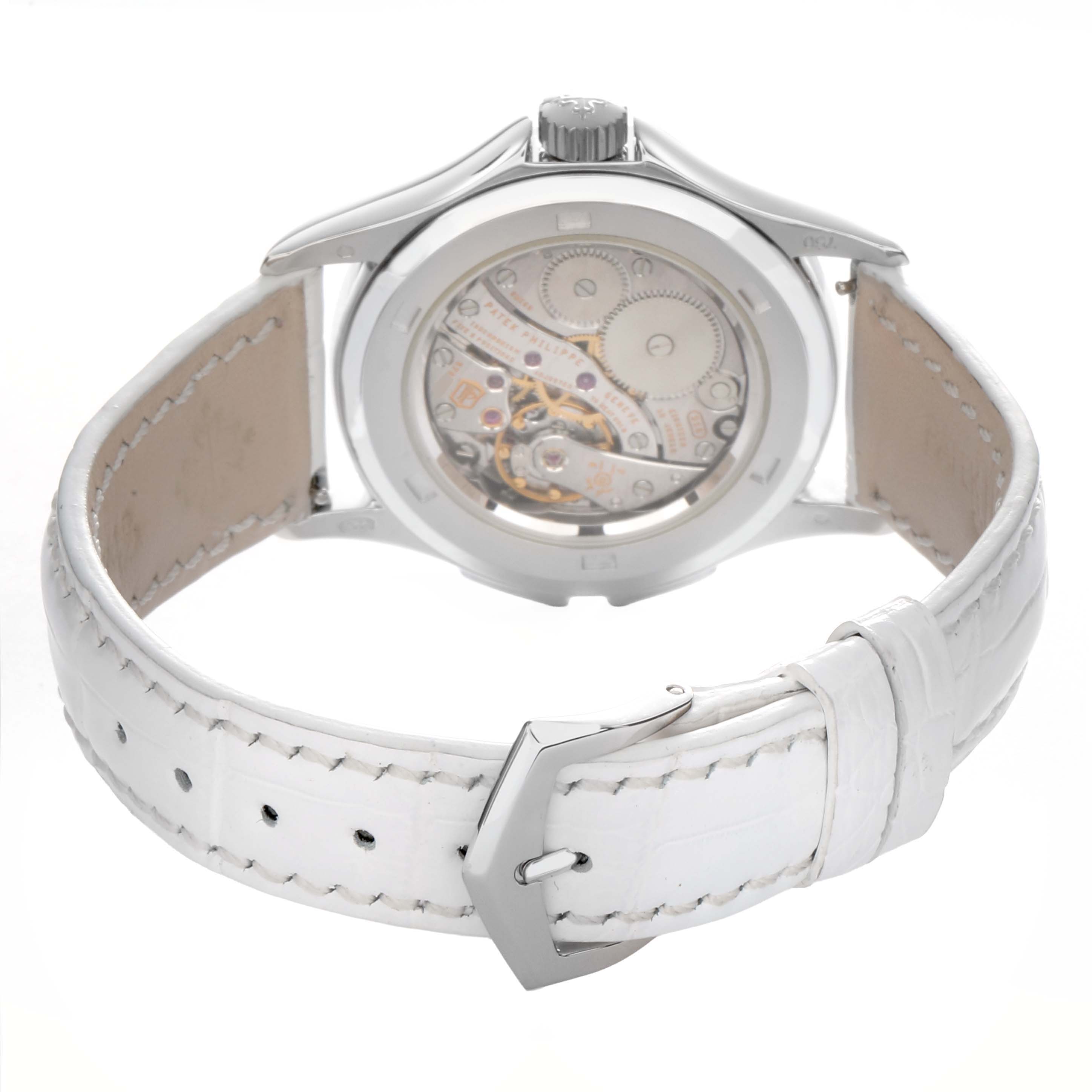 The image shows a Patek Philippe Calatrava 4934G-001 Women's White Gold Mother of Pearl Dial watch from the rear, highlighting the movement and white leather strap.