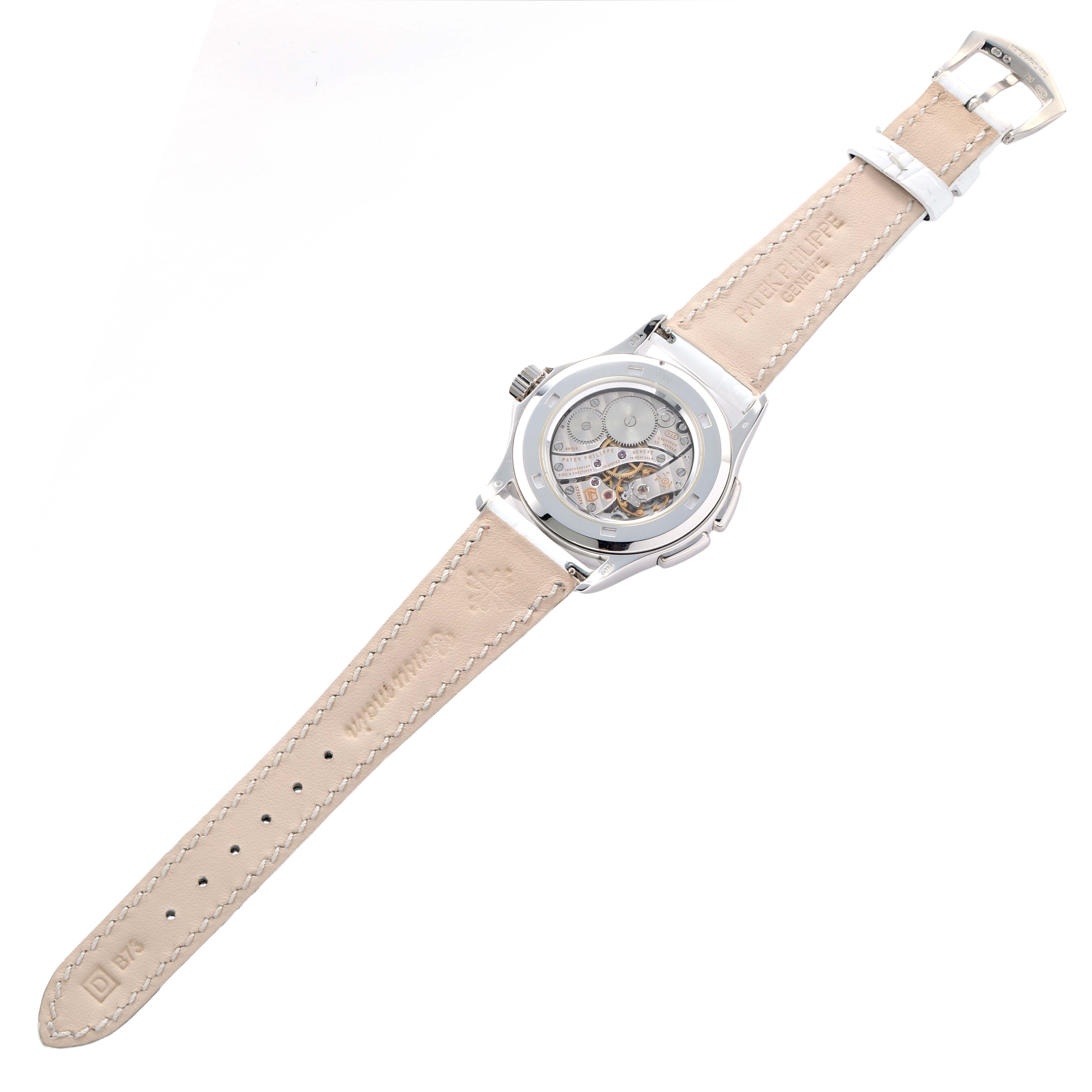 The image shows the back of the Patek Philippe Calatrava 4934G-001 Women's White Gold Mother of Pearl Dial watch, highlighting the movement and leather strap with embossed branding.