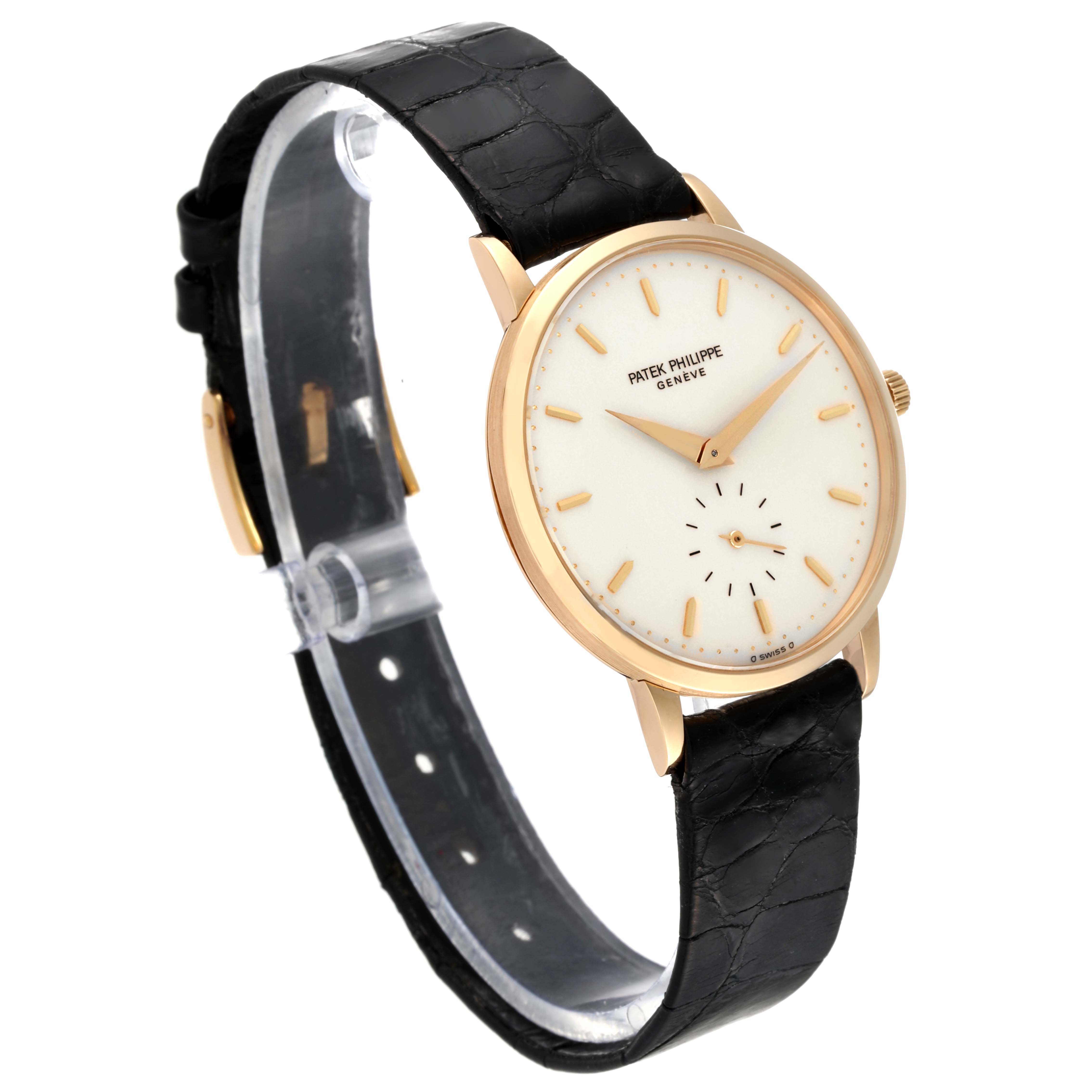 The image shows a Patek Philippe Calatrava 3893J Men
s Yellow Gold White Dial 3893J Men
s Yellow Gold White Dial model watch at an angle, highlighting the face, black leather strap, and gold casing.