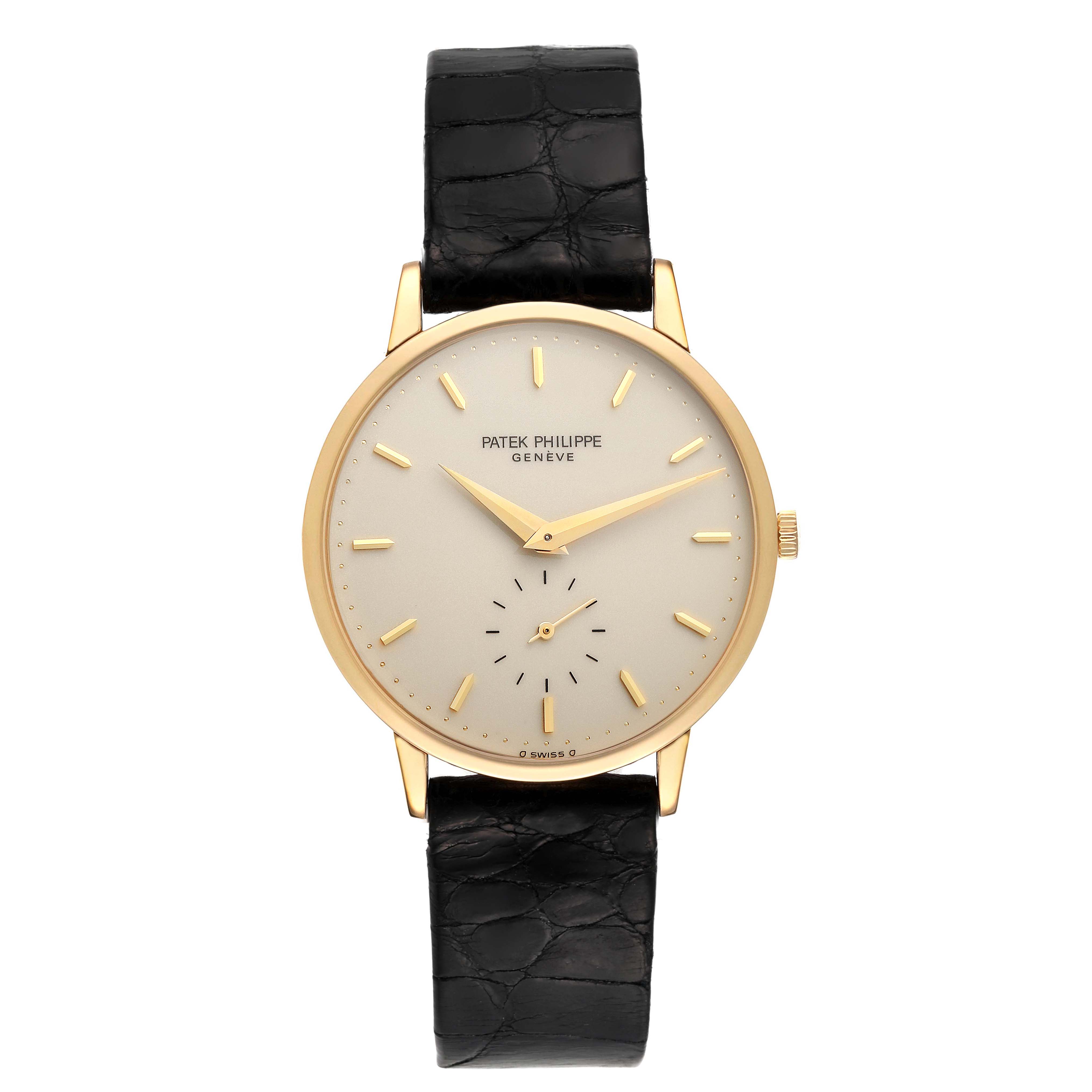 The image shows a front view of a Patek Philippe Calatrava 3893J Men
s Yellow Gold White Dial 3893J Men
s Yellow Gold White Dial watch with a black leather strap and a gold case.