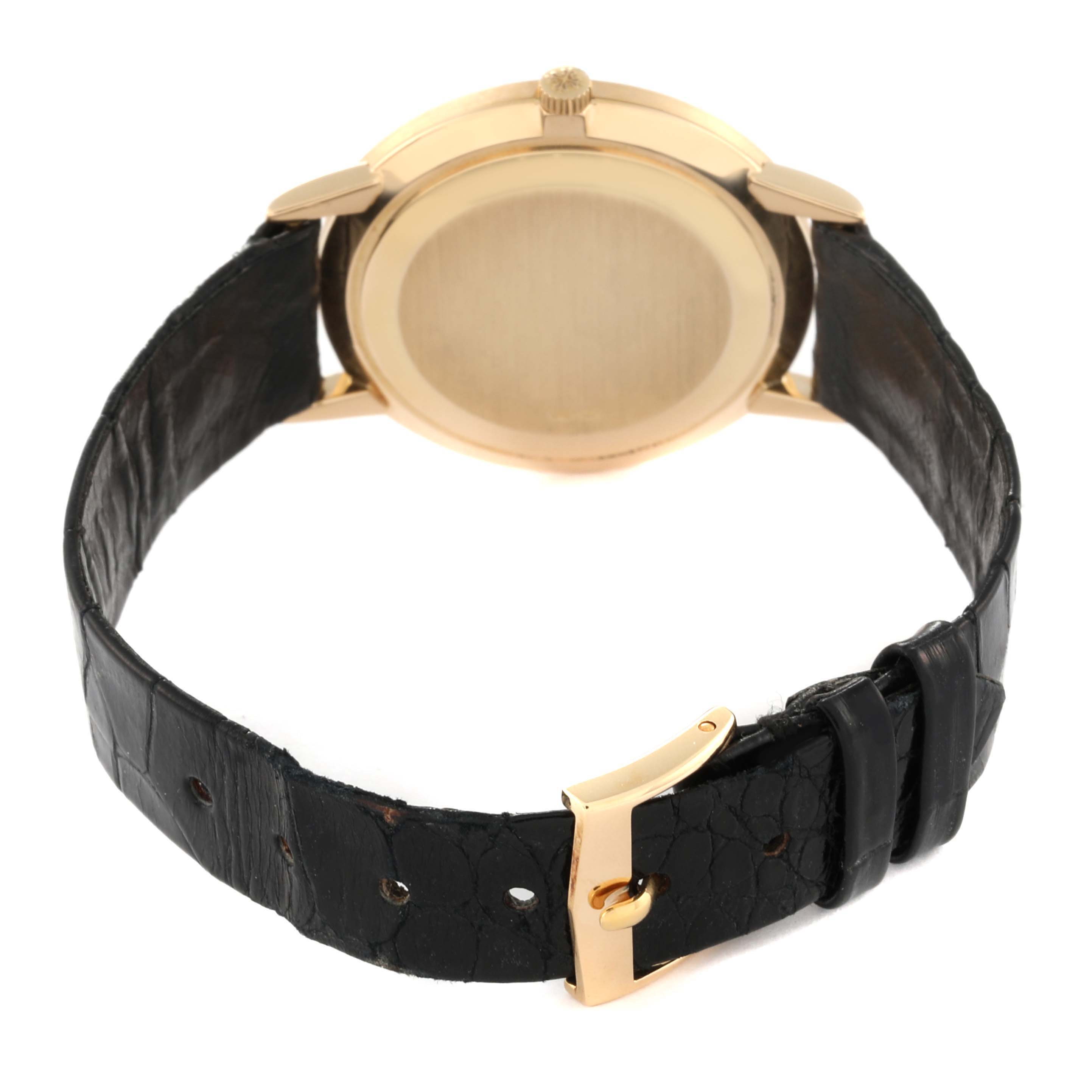 This image shows the back view of the Patek Philippe Calatrava 3893J Men
s Yellow Gold White Dial 3893J Men
s Yellow Gold White Dial watch, highlighting its case and leather strap with a clasp.