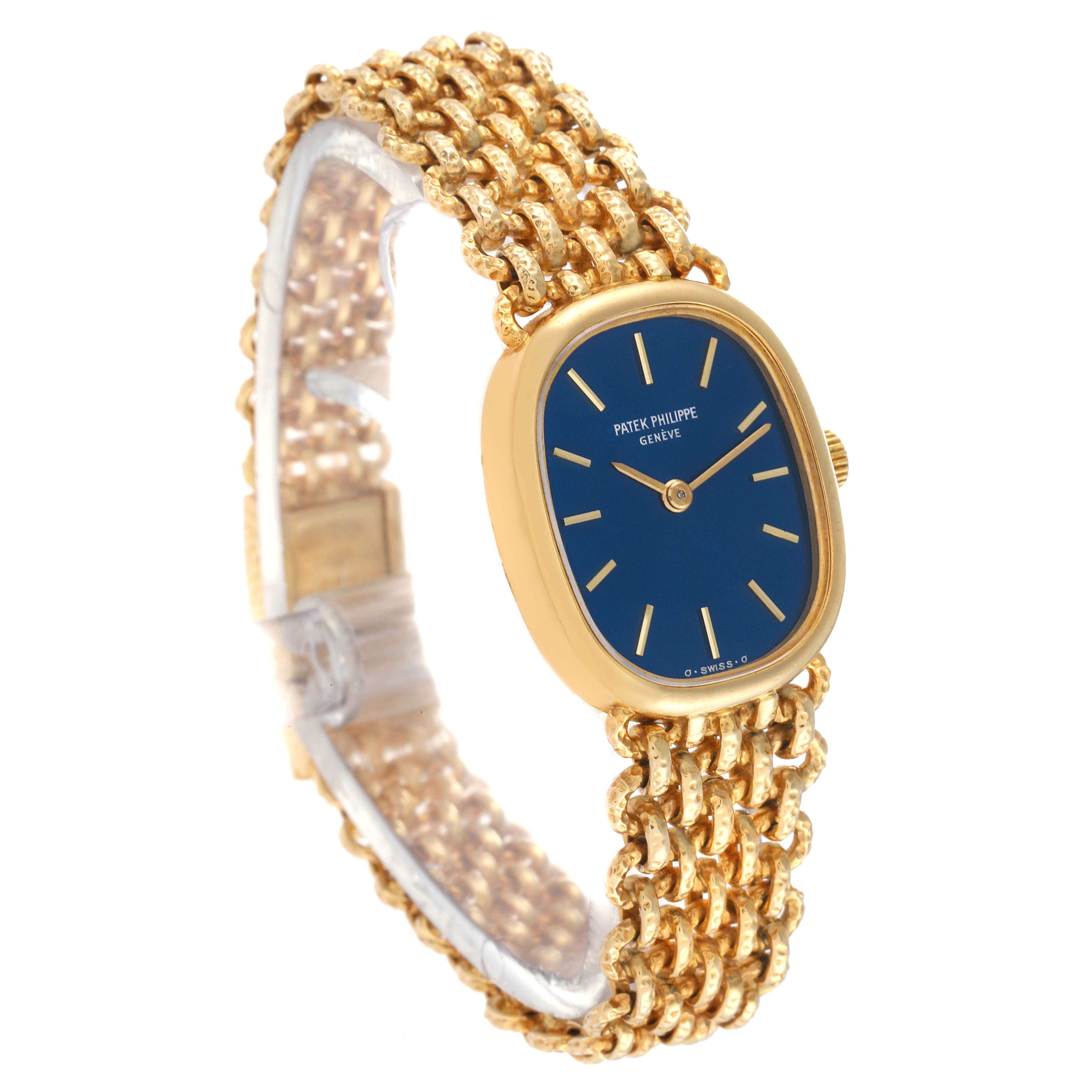 The image shows a side angle of the Patek Philippe Golden Ellipse 4464/4 Women's Yellow Gold Blue Dial 4464/4 Women's Yellow Gold Blue Dial watch featuring its distinctive blue dial and gold bracelet.