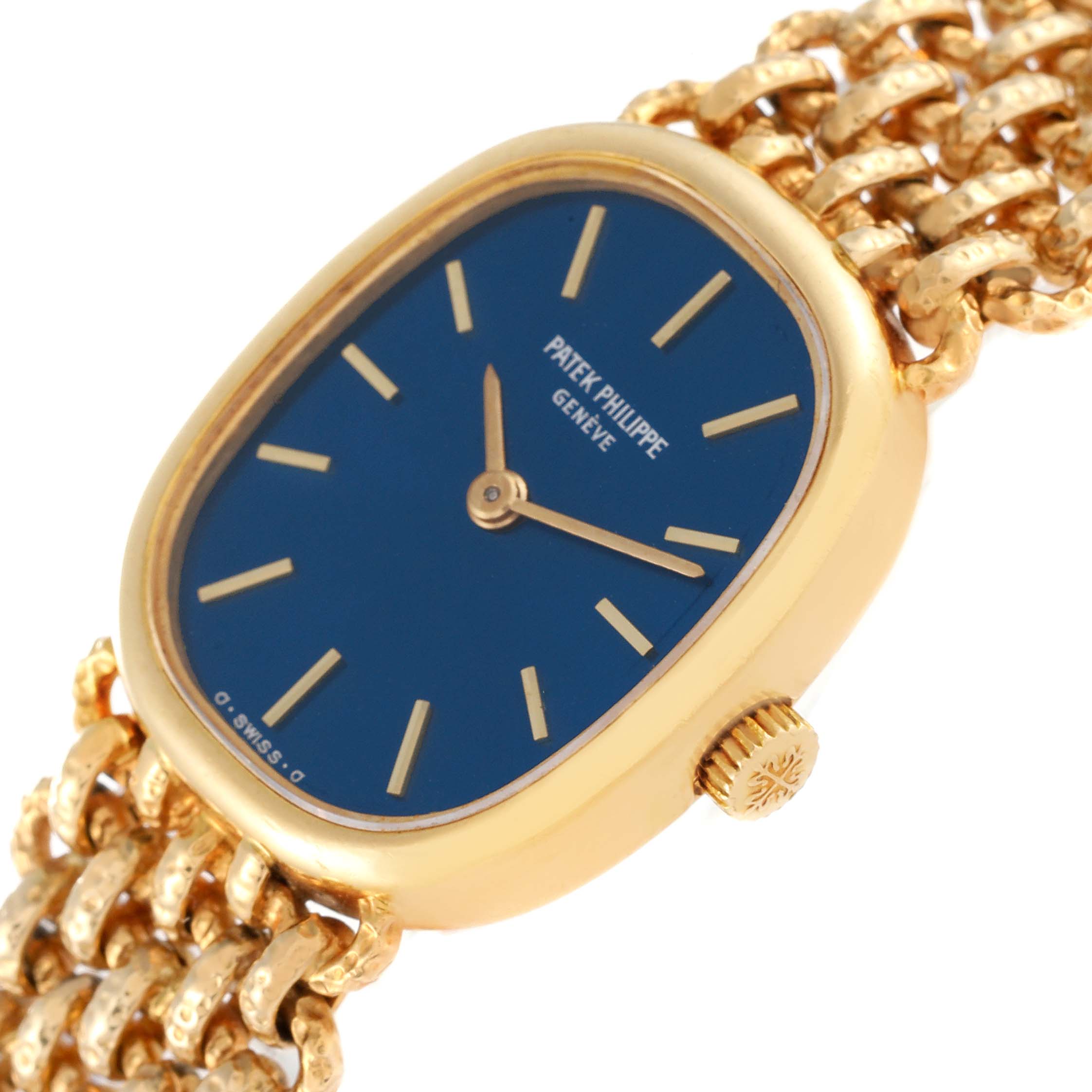 This image shows the Patek Philippe Golden Ellipse 4464/4 Women's Yellow Gold Blue Dial 4464/4 Women's Yellow Gold Blue Dial watch at an angled side view, highlighting its blue dial, gold case, and crown.