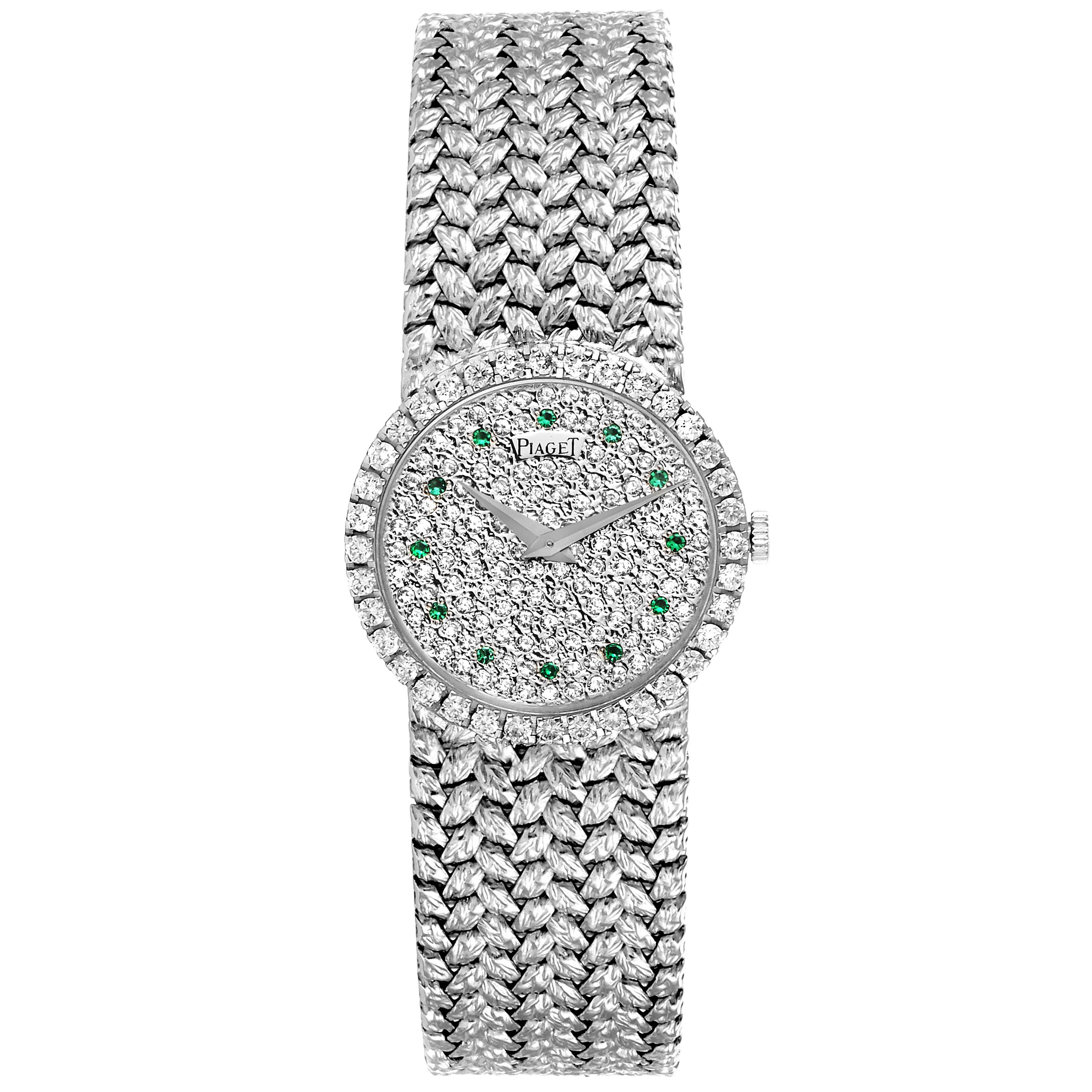 The Piaget 9706 Women's White Gold  9706 Women's White Gold  Model 9706 is shown from a top-down angle, displaying its diamond-studded face, emerald markers, and intricate band.