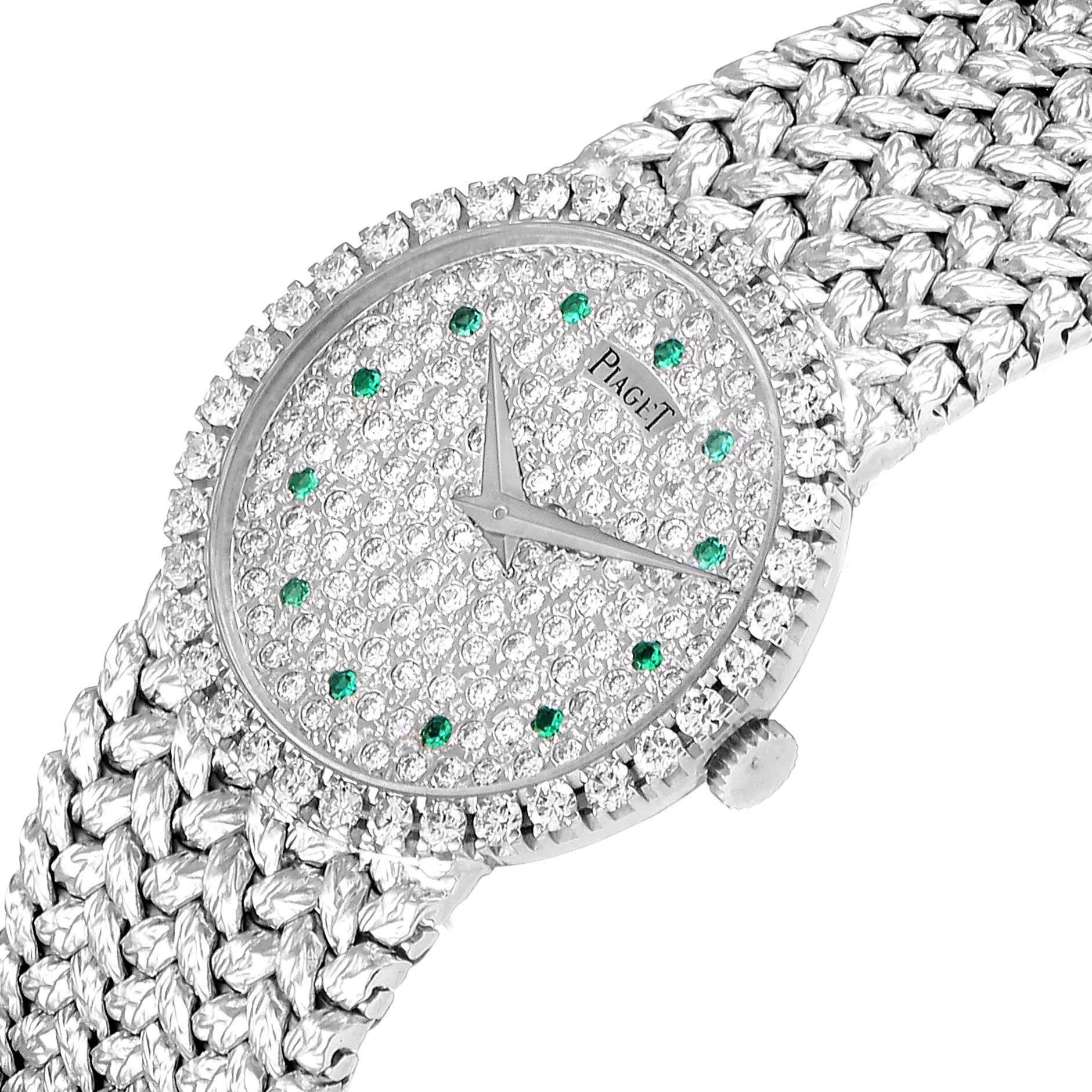The image shows the dial, bezel, crown, and part of the bracelet of the Piaget 9706 Women's White Gold  9706 Women's White Gold  9706 White Gold Pave Diamond Emerald Dial Vintage Cocktail Ladies Watch.