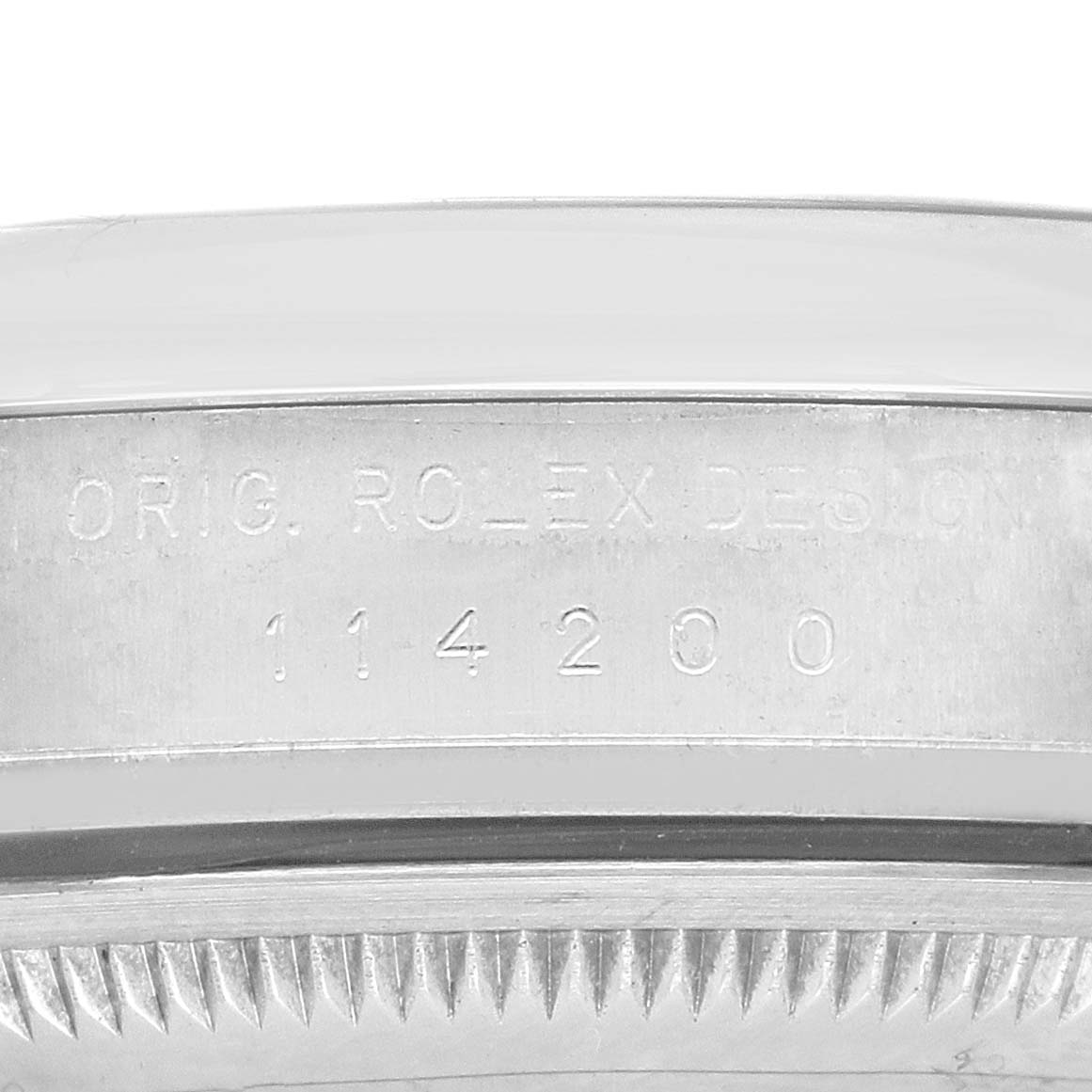 The image shows a close-up of the side of a Rolex Air-King 114200 Men's Stainless Steel White Dial, focusing on the engraved model number "114200."