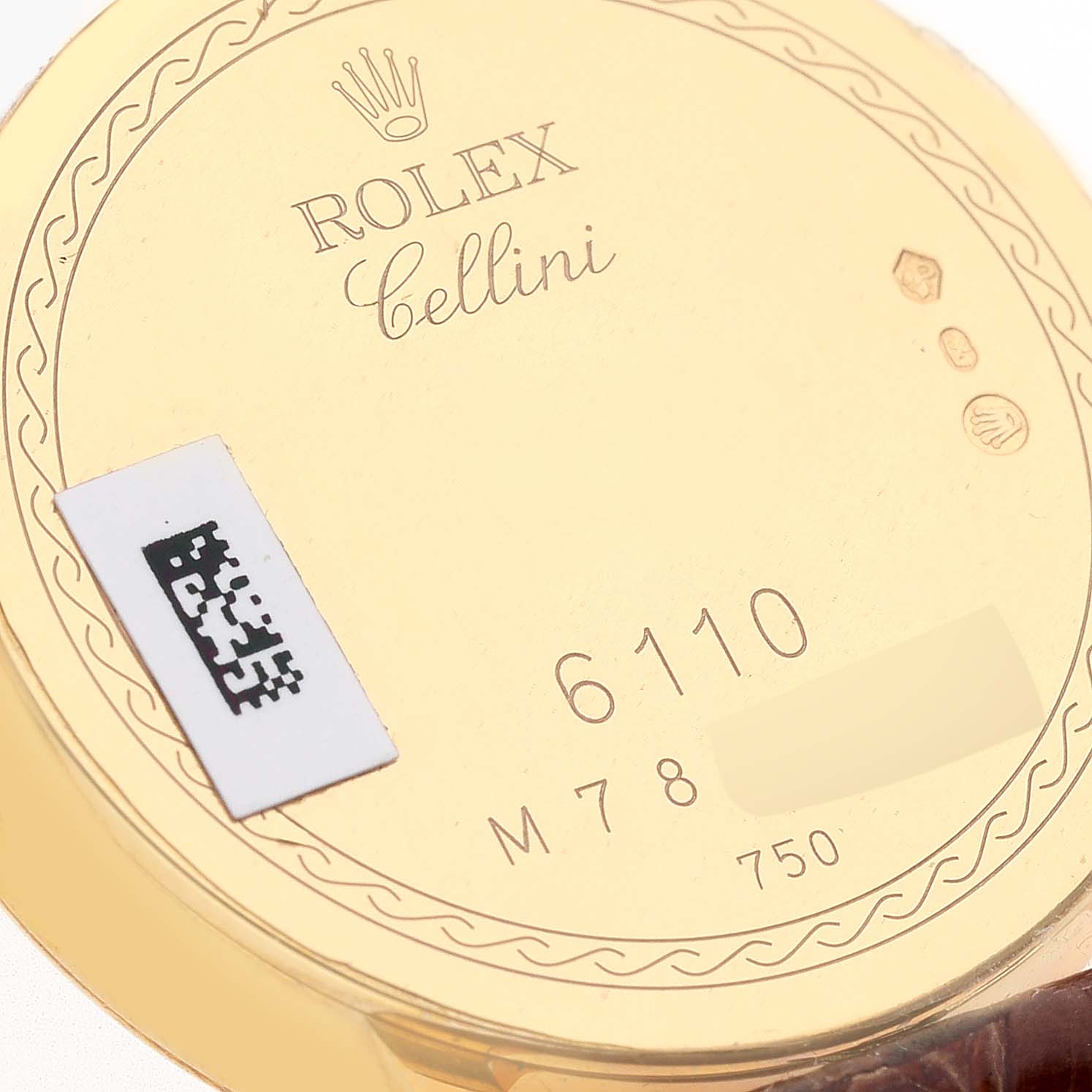 This is a close-up view of the back of a Rolex Cellini 6110/8 Women's Yellow Gold Champagne Dial 6110/8 Women's Yellow Gold Champagne Dial watch showing the model number "6110" and gold content "750."