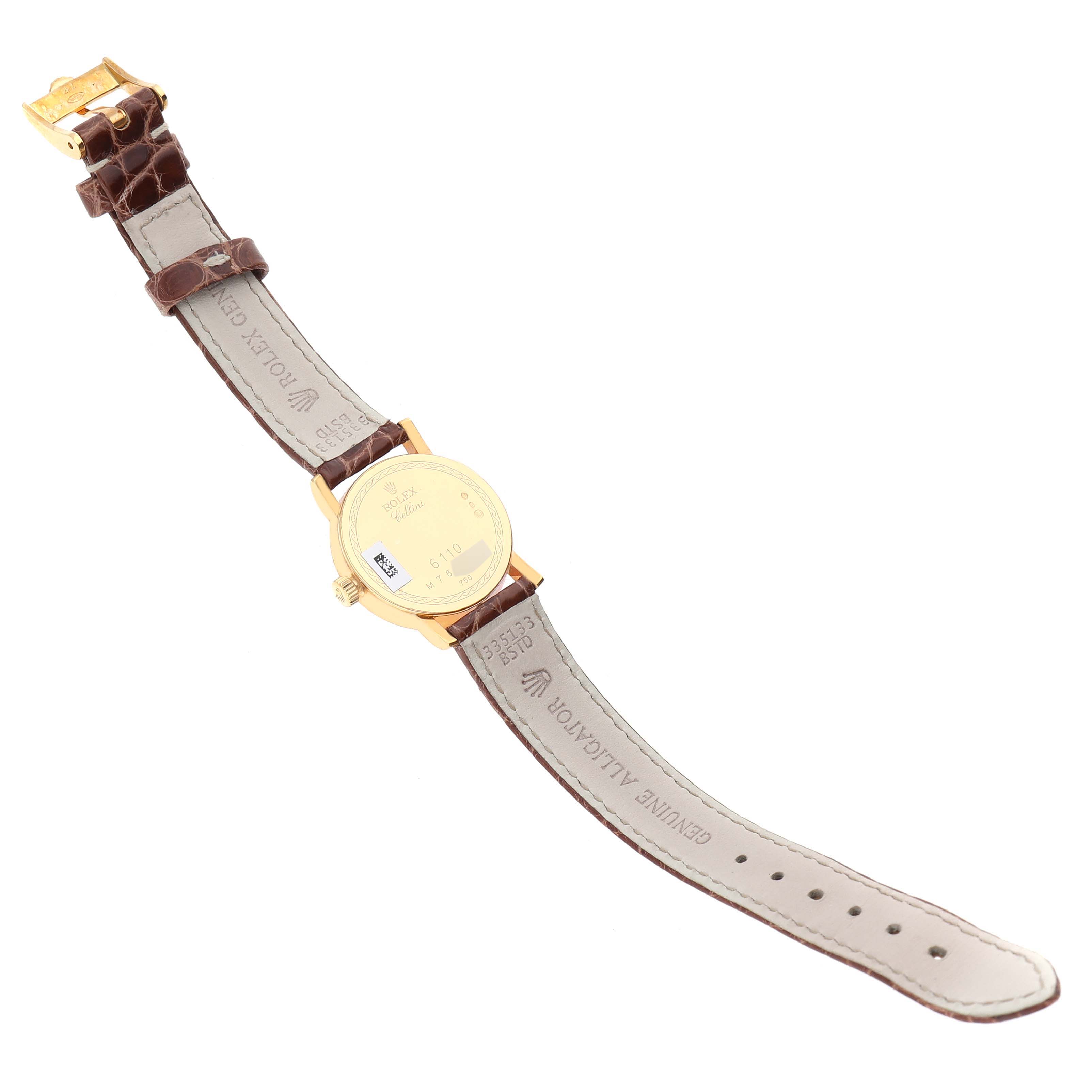 The image shows a Rolex Cellini 6110/8 Women's Yellow Gold Champagne Dial 6110/8 Women's Yellow Gold Champagne Dial watch from the back, displaying its casing, crown, and leather strap.