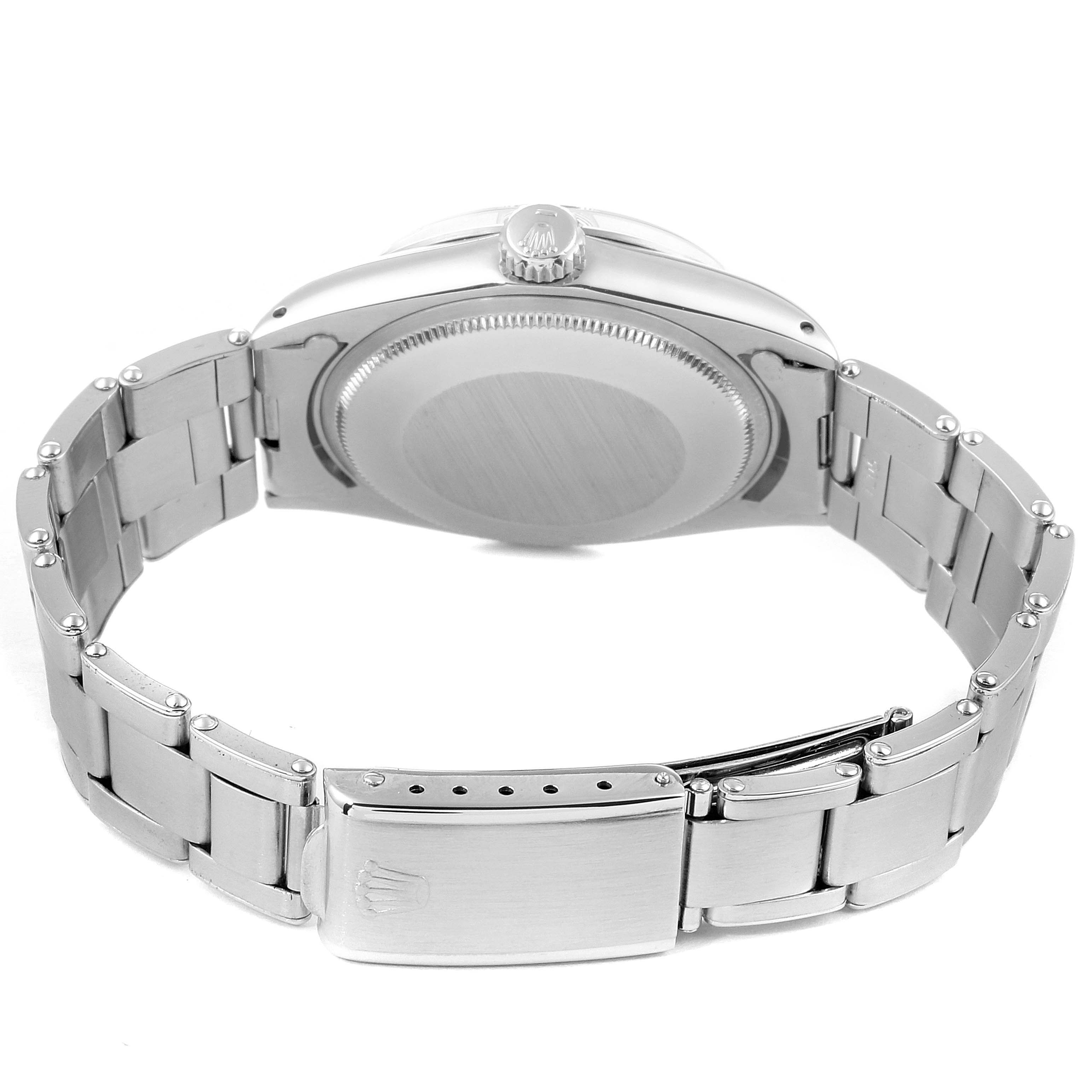 The image shows the back view of a Rolex Vintage Collection 1500 Men
s Stainless Steel Black Dial 1500 Men
s Stainless Steel Black Dial watch, featuring the case back, crown, and part of the metal bracelet.