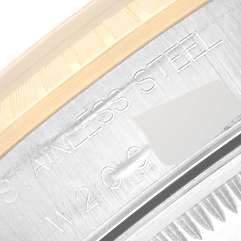 The image shows a close-up of the side of a Rolex Date 15223 Men's Steel and Gold (two tone) Black Dial 15223 Men's Steel and Gold (two tone) Black Dial model, highlighting the stainless steel and the fluted bezel.