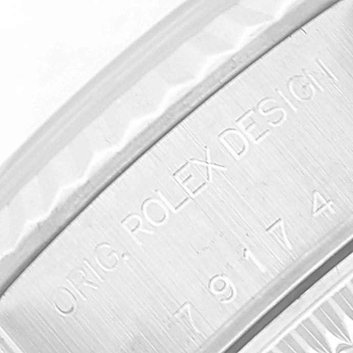 The image shows a close-up of the inner bezel of a Rolex Datejust 79174 Women's Stainless Steel Black Dial 79174 Women's Stainless Steel Black Dial, featuring engraved text and the serial number.