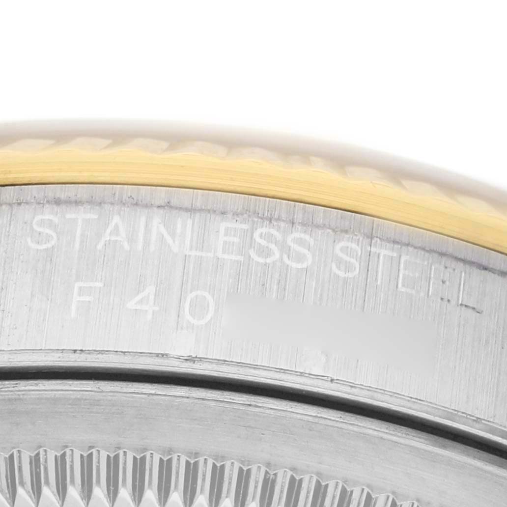 The image shows a close-up of the engraved side and bezel of a Rolex Datejust 16233 Men's Steel and Gold (two tone) Silver Dial model.