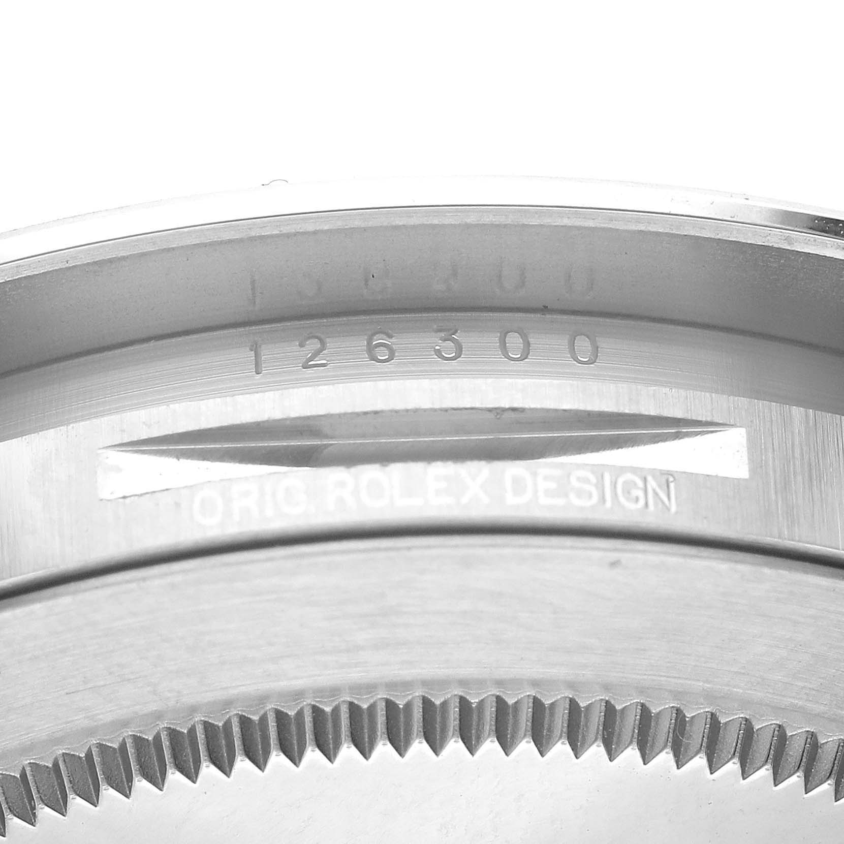This close-up image shows the engraved reference number (126300) and "ORIG ROLEX DESIGN" on the inner bezel of a Rolex Datejust 41 126300 Men
s Stainless Steel Blue Dial 126300 Men
s Stainless Steel Blue Dial.
