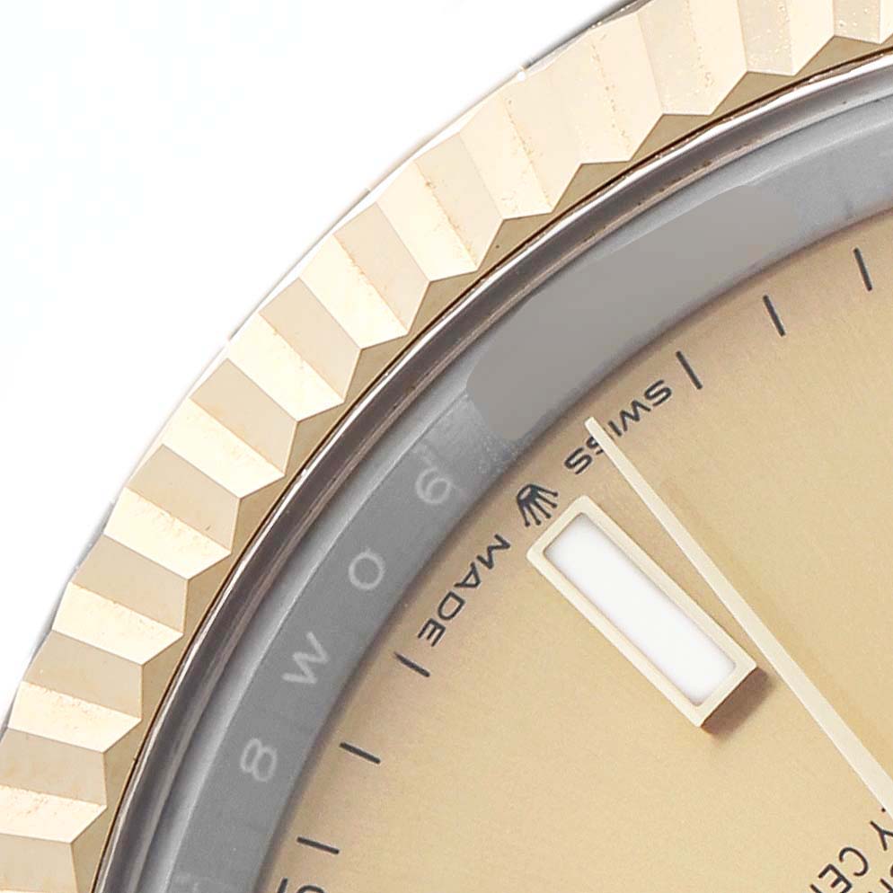 The image shows a close-up of the fluted bezel and part of the dial with markers on a Rolex Datejust 41 126333 Men's Steel and Gold (two tone) Champagne Dial.