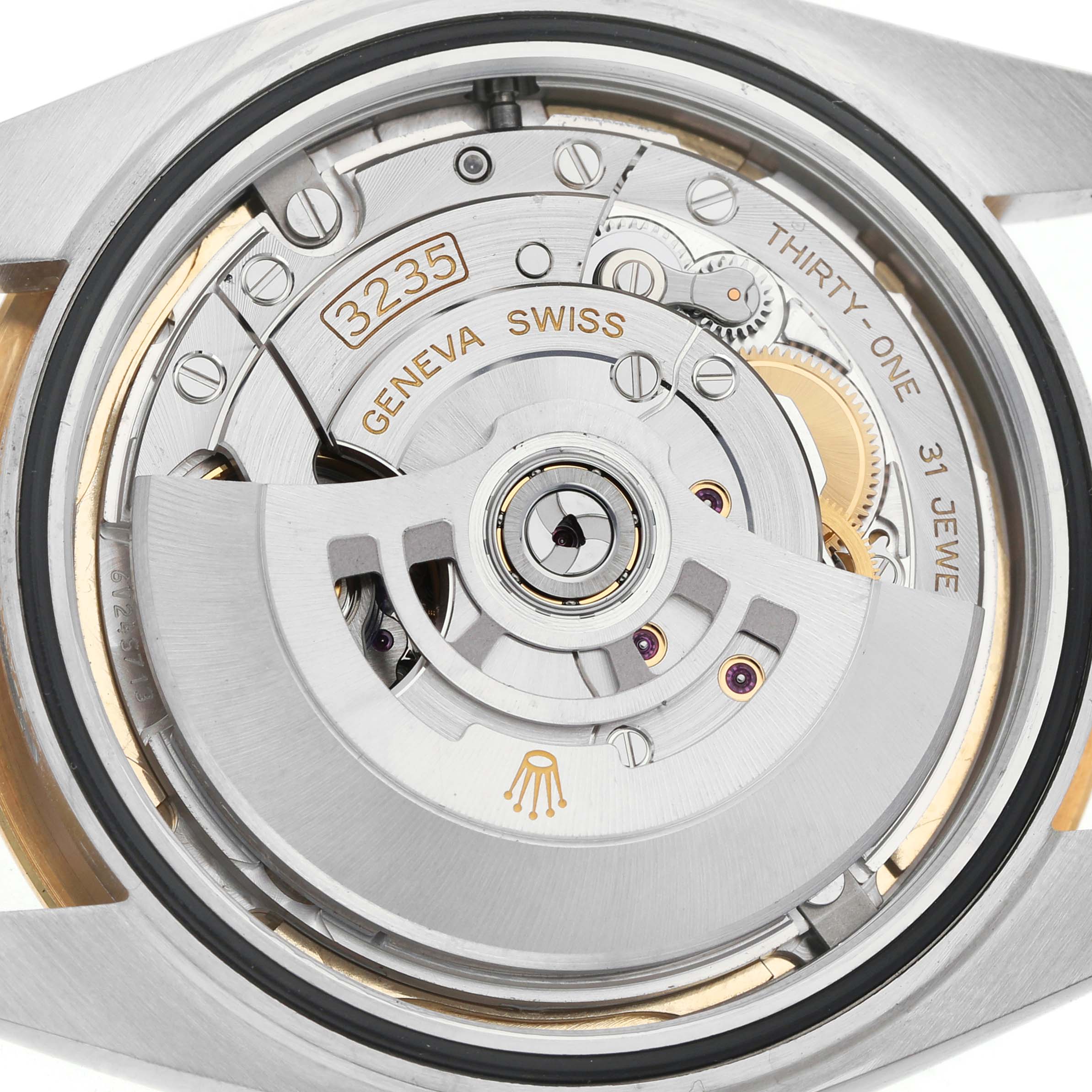 The image shows the movement of a Rolex Datejust 41 126333 Men's Steel and Gold (two tone) Champagne Dial, viewed from the back, highlighting its intricate mechanics and rotor.