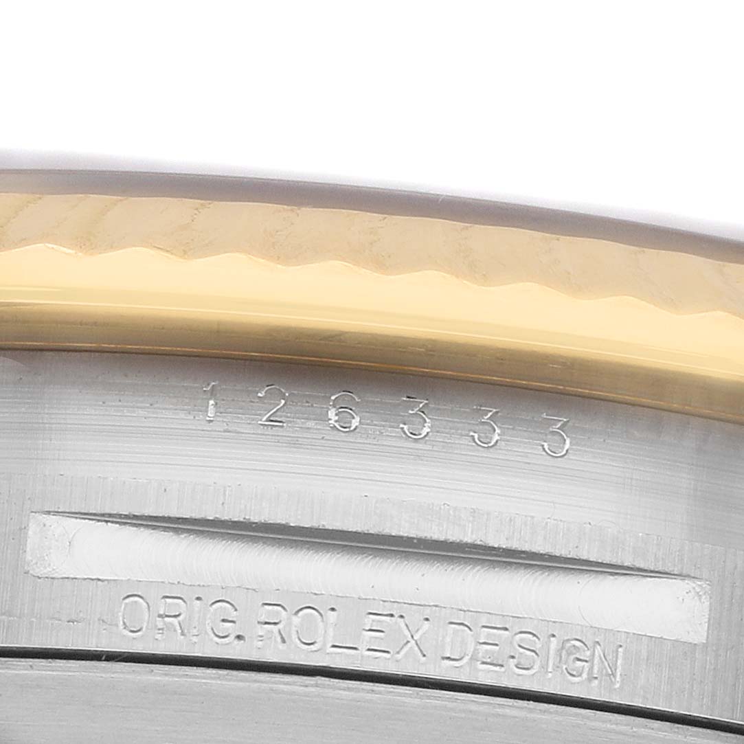 The image shows a close-up of the side of a Rolex Datejust 41 126333 Men's Steel and Gold (two tone) Champagne Dial watch, highlighting the bezel and case with engraved design details.