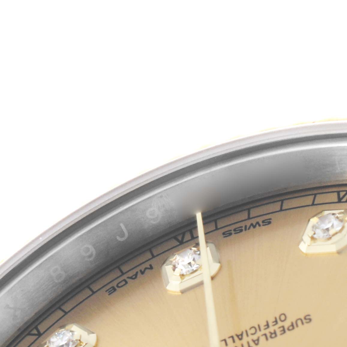 The image shows a close-up of the dial's edge of a Rolex Datejust 41 126333 Men's Steel and Gold (two tone) Champagne Dial, highlighting diamond markers and the gold dial.