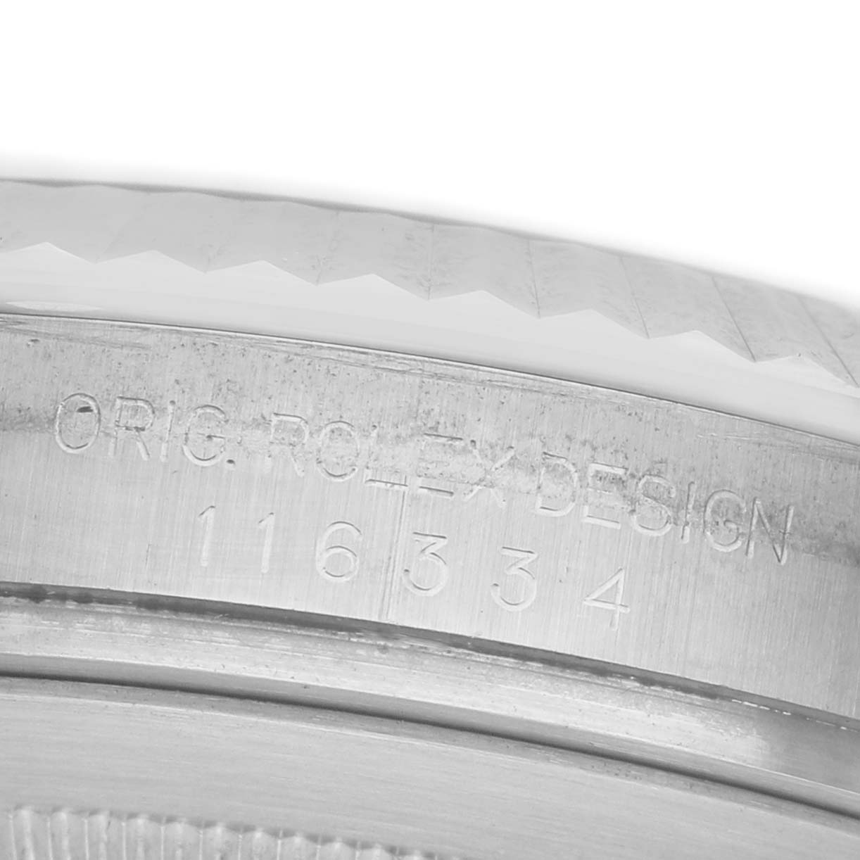 The image shows a close-up of the engraved bezel edge of a Rolex Datejust 41 116334 Men's Stainless Steel Silver Dial, highlighting the text "ORIG. ROLEX DESIGN 116334."