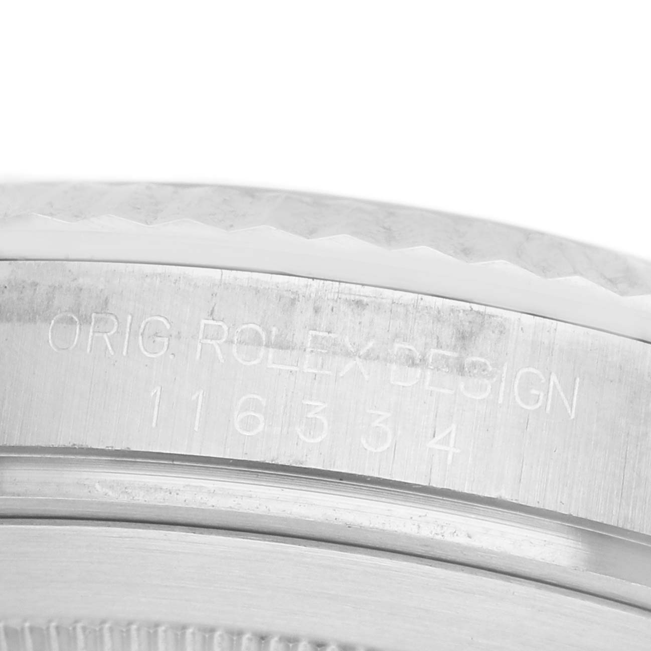 The image shows a close-up of the case side of a Rolex Datejust 41 116334 Men's Stainless Steel Black Dial, focusing on the engraved serial and model numbers.