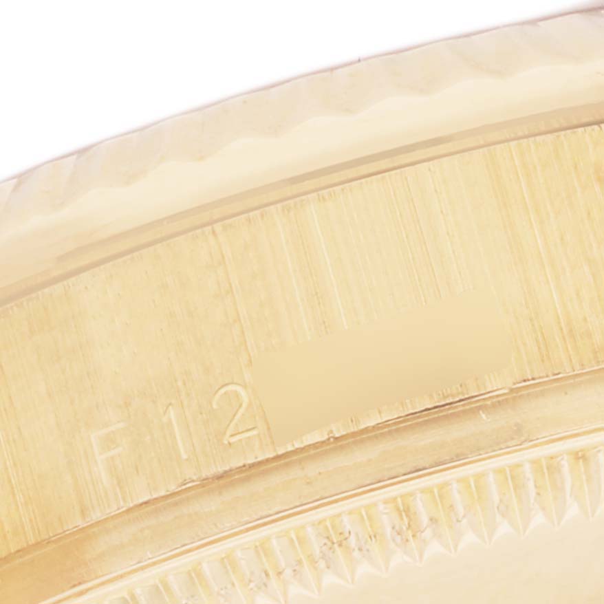 This image shows a close-up of the bezel and serial number area of a Rolex President 178278 Women
s Yellow Gold Black Dial 178278 Women
s Yellow Gold Black Dial model watch. 