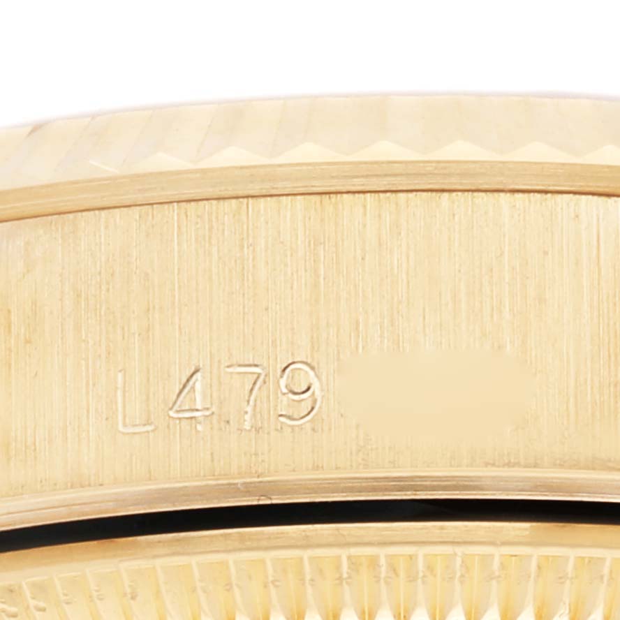 This image shows a close-up of the watch case back and serial number on a Rolex President 69178 Women's Yellow Gold Champagne Dial 69178 Women's Yellow Gold Champagne Dial model.