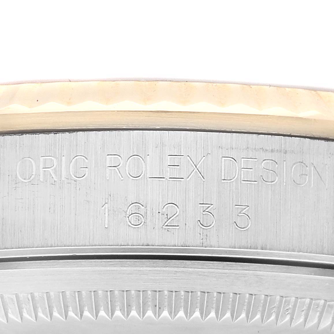 The image shows a close-up of the side of a Rolex Datejust 16233 Men's Steel and Gold (two tone) Champagne Dial 16233 Men's Steel and Gold (two tone) Champagne Dial watch case, revealing the "ORIG ROLEX DESIGN 16233" engraving.