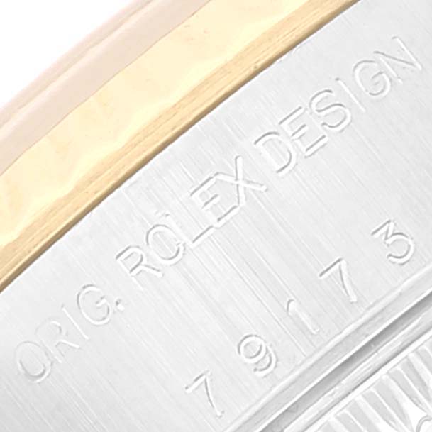 The image shows a close-up of the engraved "Orig. Rolex Design" on the case of a Rolex Datejust 79173 Women's Steel and Gold (two tone) Silver Dial 79173 Women's Steel and Gold (two tone) Silver Dial model.