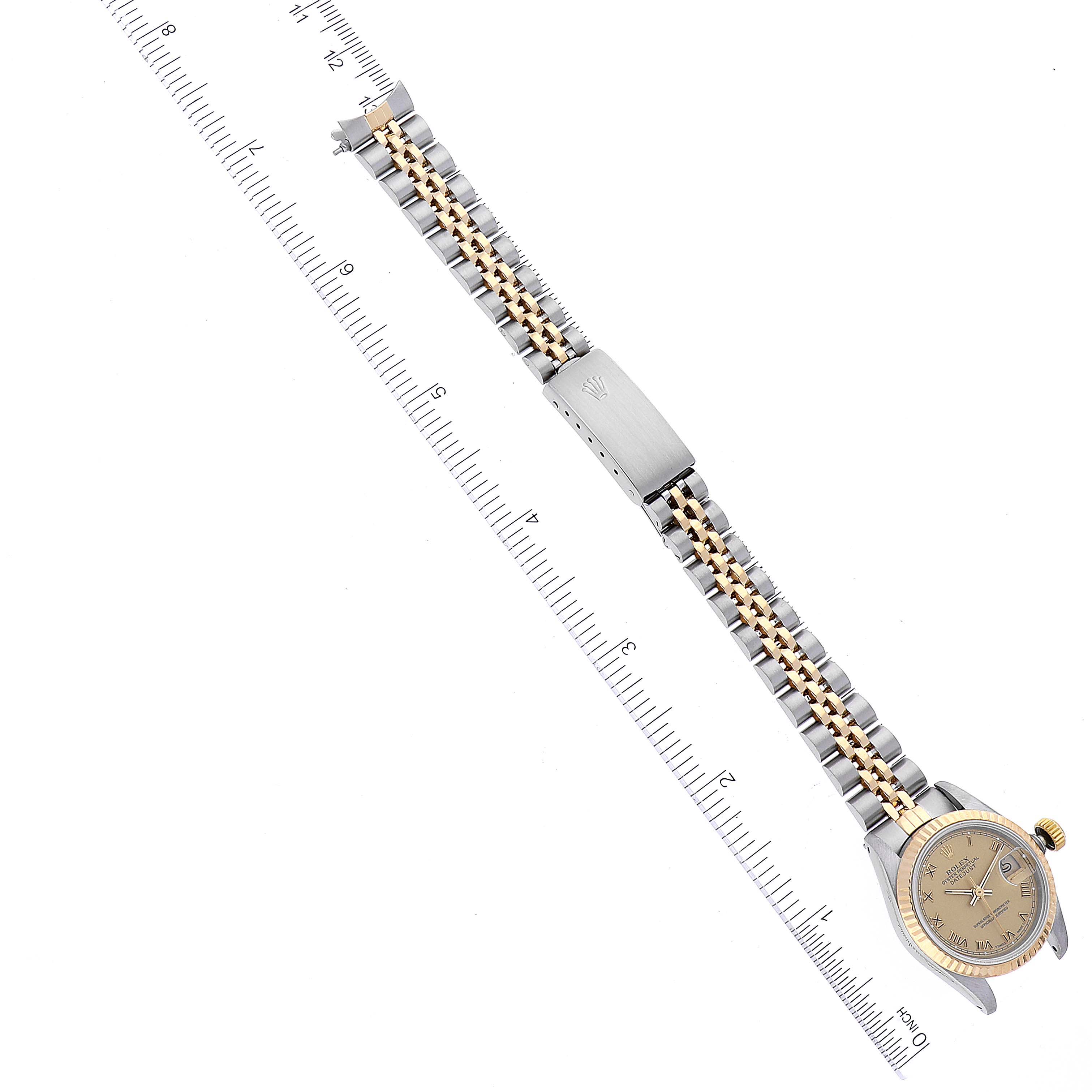 The image shows a Rolex Datejust 69173 Women's Steel and Gold (two tone) Champagne Dial 69173 Women's Steel and Gold (two tone) Champagne Dial watch laid flat with a view of its face, bracelet, and clasp next to a ruler for scale.