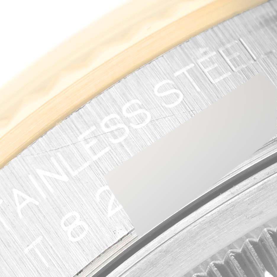 This close-up image shows part of the bezel and case engraving of a Rolex Datejust 16233 Men's Steel and Gold (two tone) Champagne Dial 16233 Men's Steel and Gold (two tone) Champagne Dial watch, highlighting its stainless steel component.