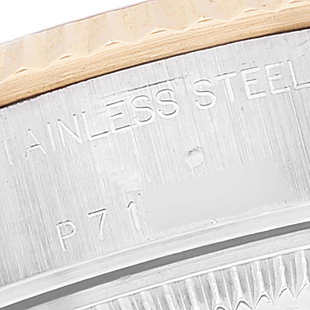 This close-up image shows the engraved edge of a Rolex Datejust 79173 Women's Steel and Gold (two tone) Champagne Dial 79173 Women's Steel and Gold (two tone) Champagne Dial watch, highlighting the words "STAINLESS STEEL".