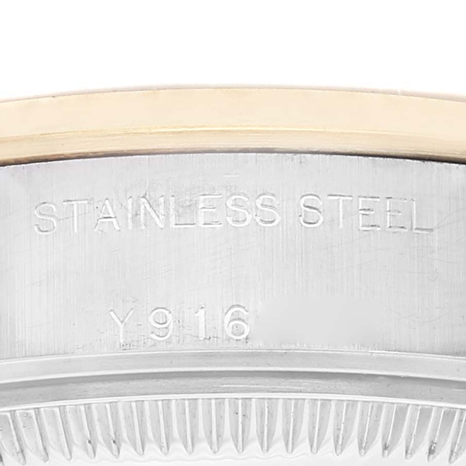 This image shows a close-up of the stainless steel and gold bezel with engravings on the Rolex Datejust 79163 Women's Steel and Gold (two tone) Grey Dial 79163 Women's Steel and Gold (two tone) Grey Dial model watch.