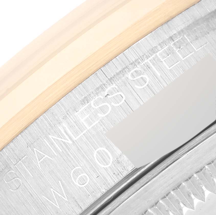 This close-up image shows the side of the bezel and part of the case back of a Rolex Datejust 16203 Men's Steel and Gold (two tone) White Dial 16203 Men's Steel and Gold (two tone) White Dial watch, highlighting the "Stainless Steel" engraving.