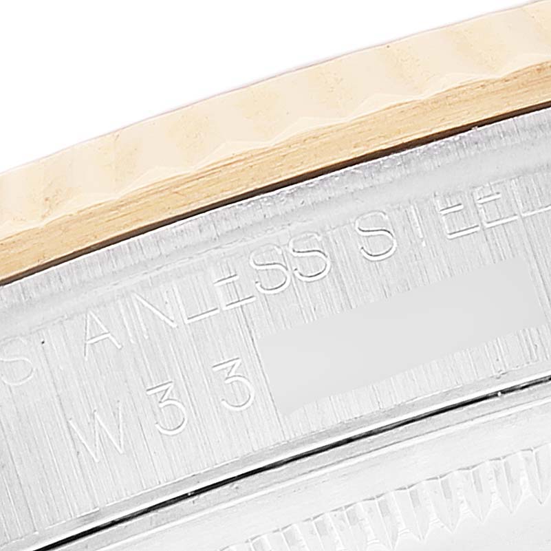 The image shows a close-up of the side of a Rolex Datejust 16233 Men's Steel and Gold (two tone) White Dial 16233 Men's Steel and Gold (two tone) White Dial watch, highlighting the stainless steel case back and partially visible text.