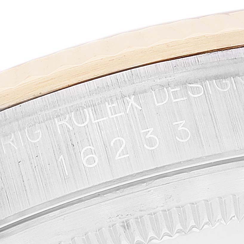 This close-up image shows part of the bezel and inner inscriptions of a Rolex Datejust 16233 Men's Steel and Gold (two tone) White Dial 16233 Men's Steel and Gold (two tone) White Dial watch.