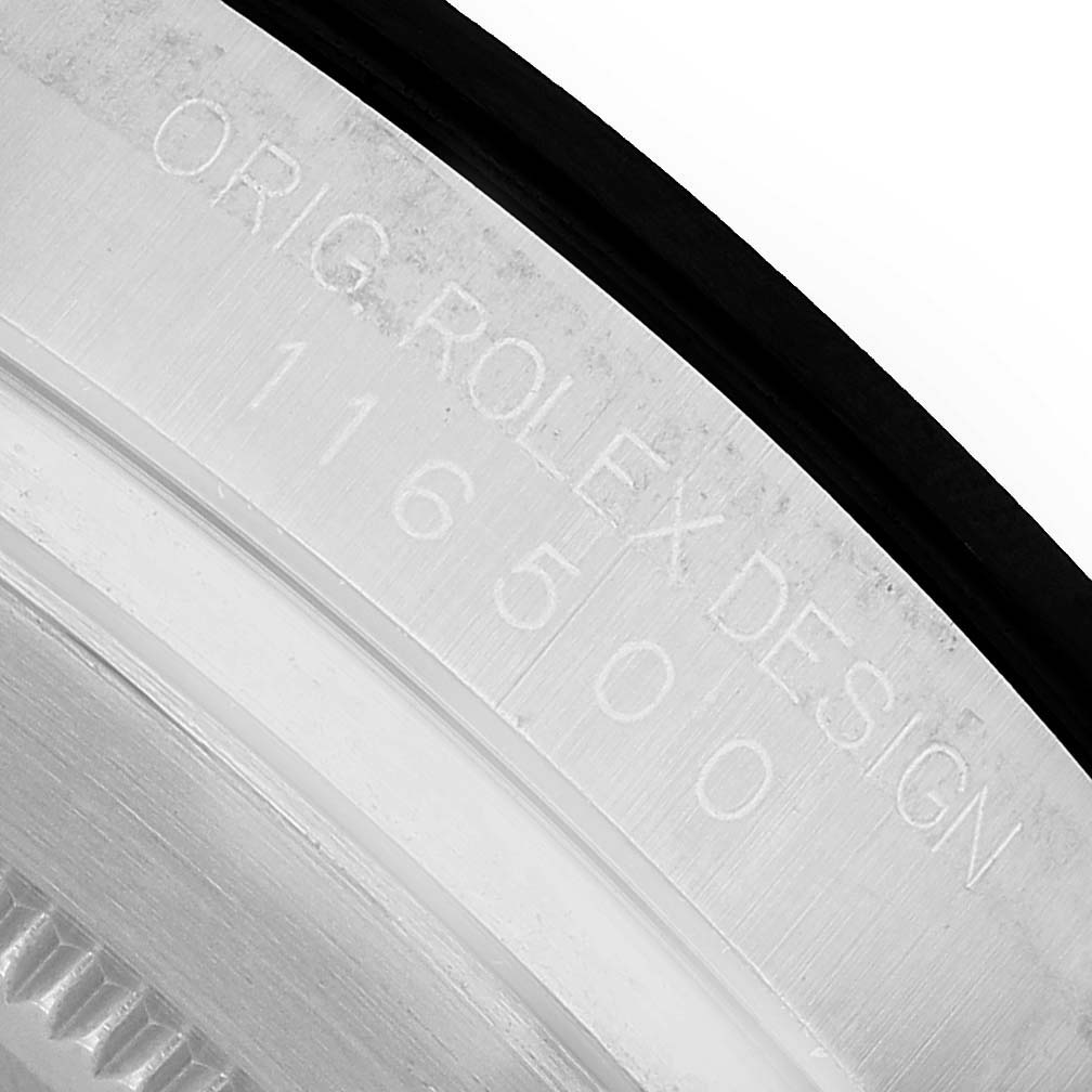 The image shows a close-up of the case edge with engraved details of a Rolex Daytona 116500LN Men's Stainless Steel Black Dial model.