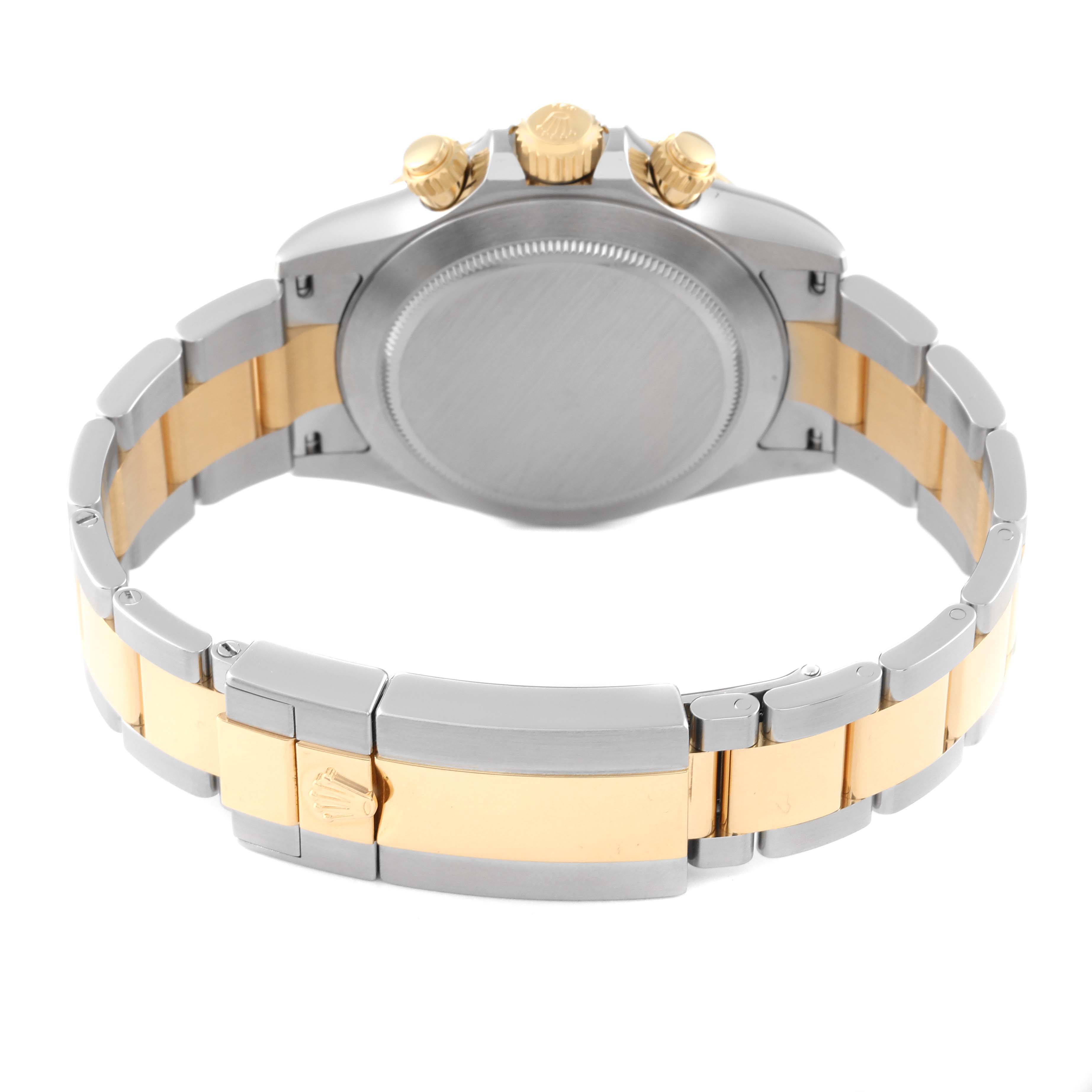 This Rolex Daytona 116503 Men's Steel and Gold (two tone) Mother of Pearl Dial 116503 Men's Steel and Gold (two tone) Mother of Pearl Dial watch is shown from the back, highlighting its two-tone bracelet and clasp, and the case back.