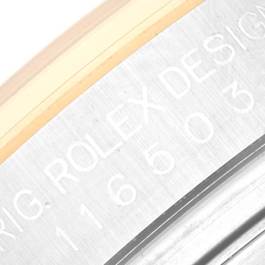 Close-up of the engraving on the side of the Rolex Daytona 116503 Men's Steel and Gold (two tone) Mother of Pearl Dial 116503 Men's Steel and Gold (two tone) Mother of Pearl Dial watch case, showing model and brand details.