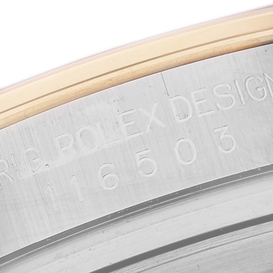 This close-up image of a Rolex Daytona 116503 Men's Steel and Gold (two tone) Mother of Pearl Dial 116503 Men's Steel and Gold (two tone) Mother of Pearl Dial watch shows the inner case engraving and part of the outer bezel.