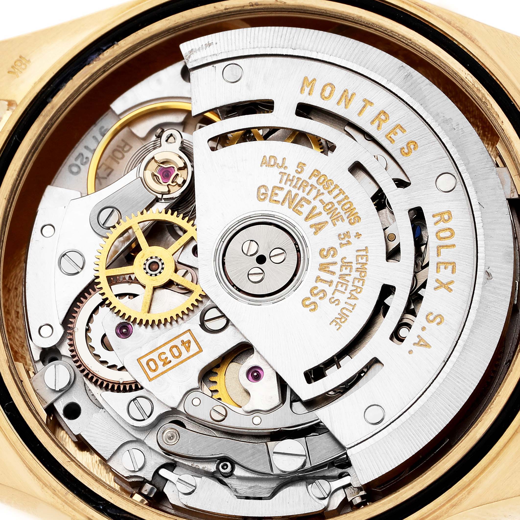 The image shows the movement and mechanisms of a Rolex Daytona 16528 Men's Yellow Gold Champagne Dial from a close-up, rear angle.