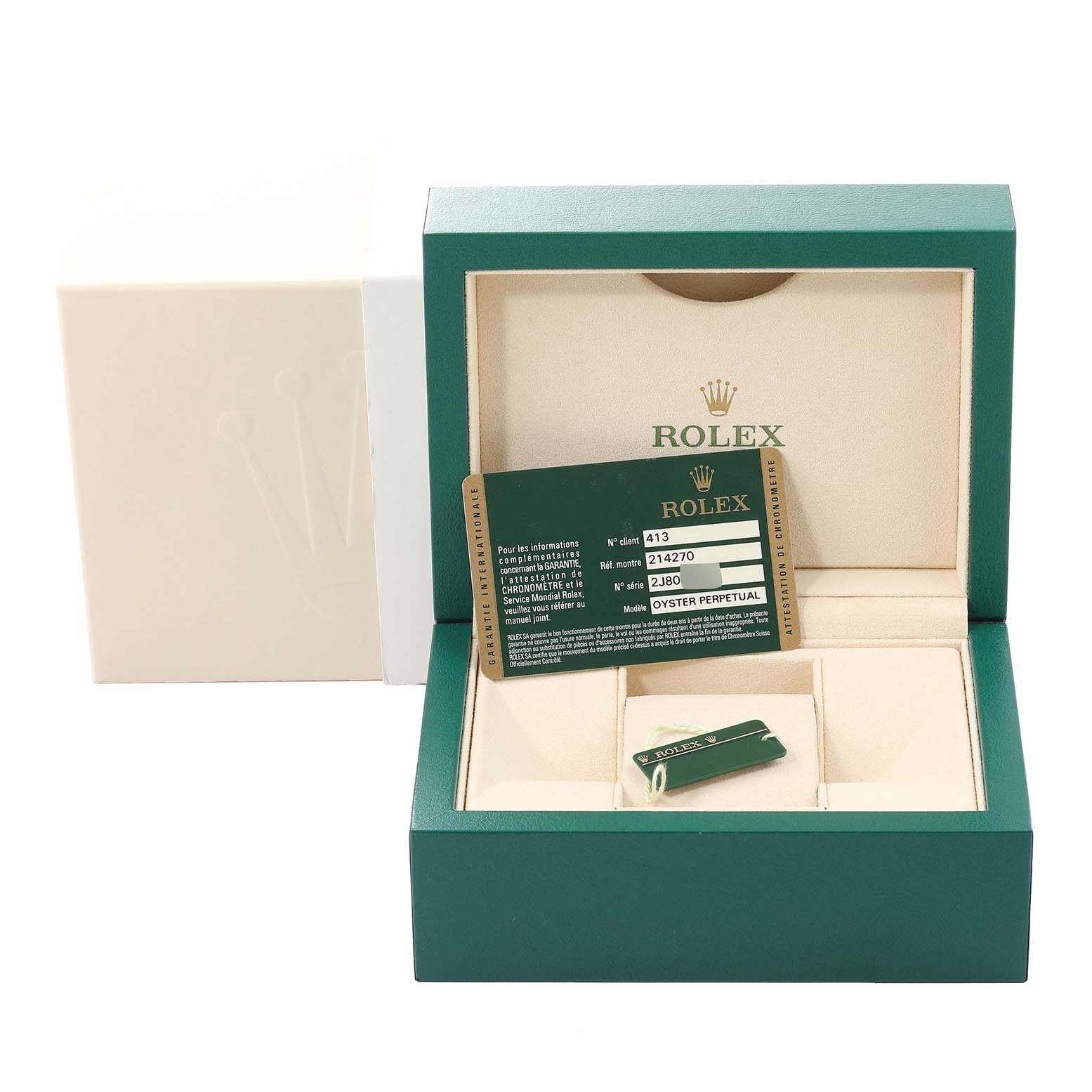 The image shows a green Rolex box and its contents, including the warranty card and accessories for the Explorer model by Rolex.