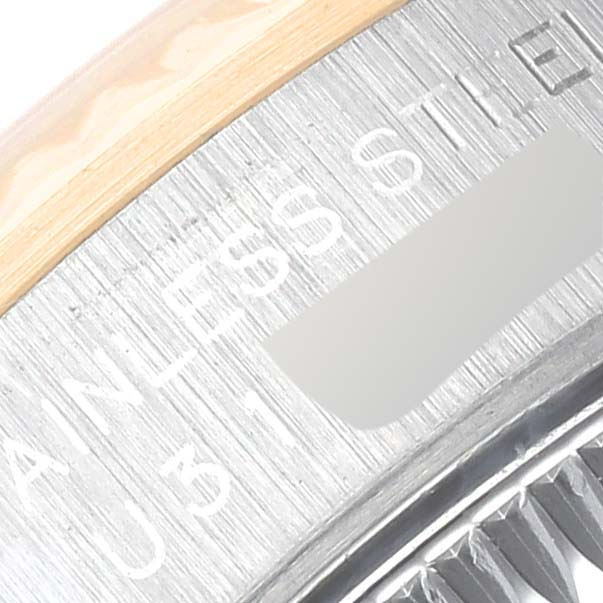 The image shows a close-up of the stainless steel case back, including the model details engraving, of a Rolex Oyster Perpetual 67193 Women's Steel and Gold (two tone) Black Dial 67193 Women's Steel and Gold (two tone) Black Dial watch.