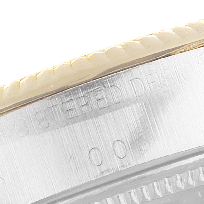 This image shows a close-up of the side view of the Rolex Vintage Collection 1002 Men
s Steel and Gold (two tone) Champagne Dial 1002 Men
s Steel and Gold (two tone) Champagne Dial watch, focusing on the bezel and engraving details.