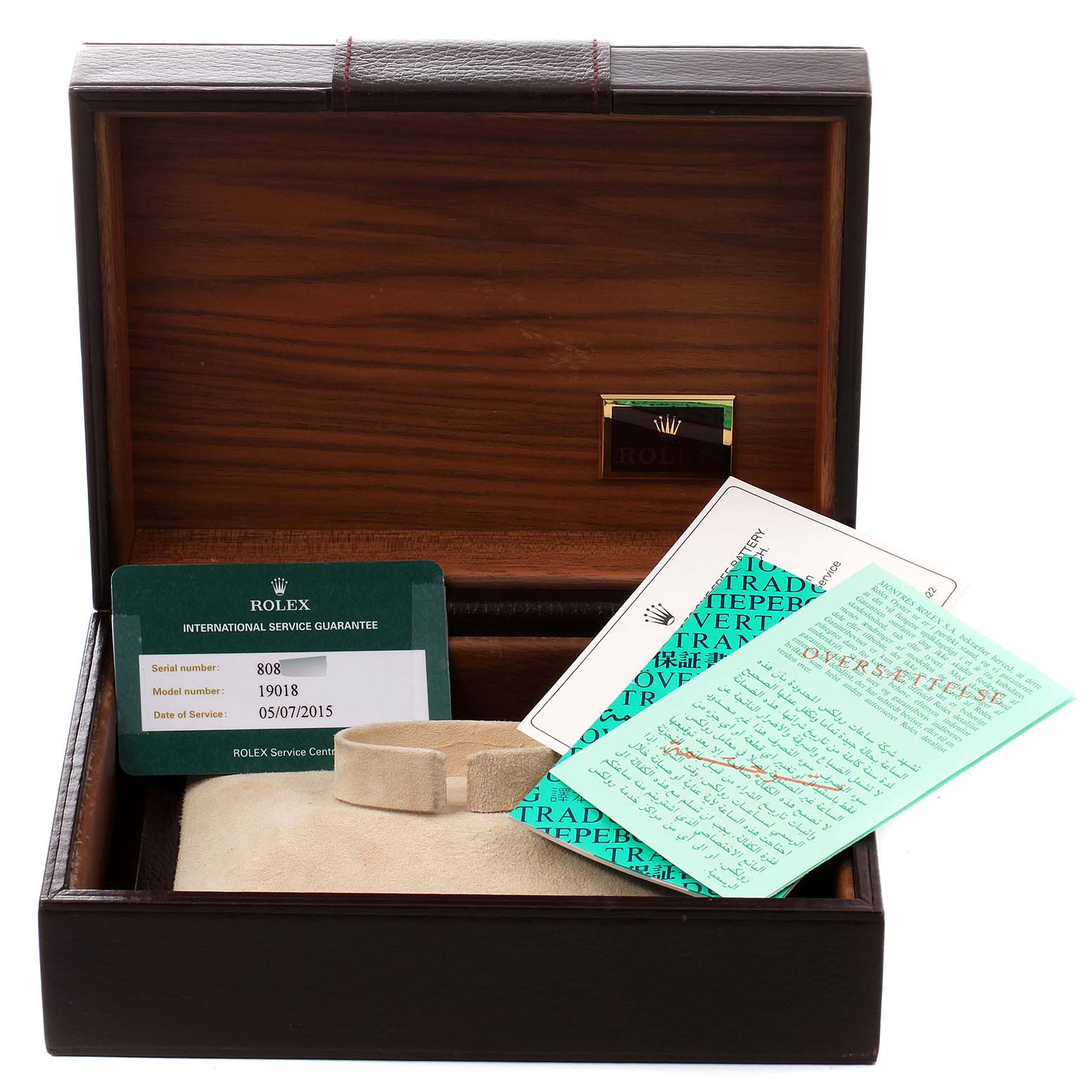 The image shows a Rolex President 19018 Men
s Yellow Gold Black Dial 19018 Men
s Yellow Gold Black Dial model watch box with international service guarantee cards and documentation inside.