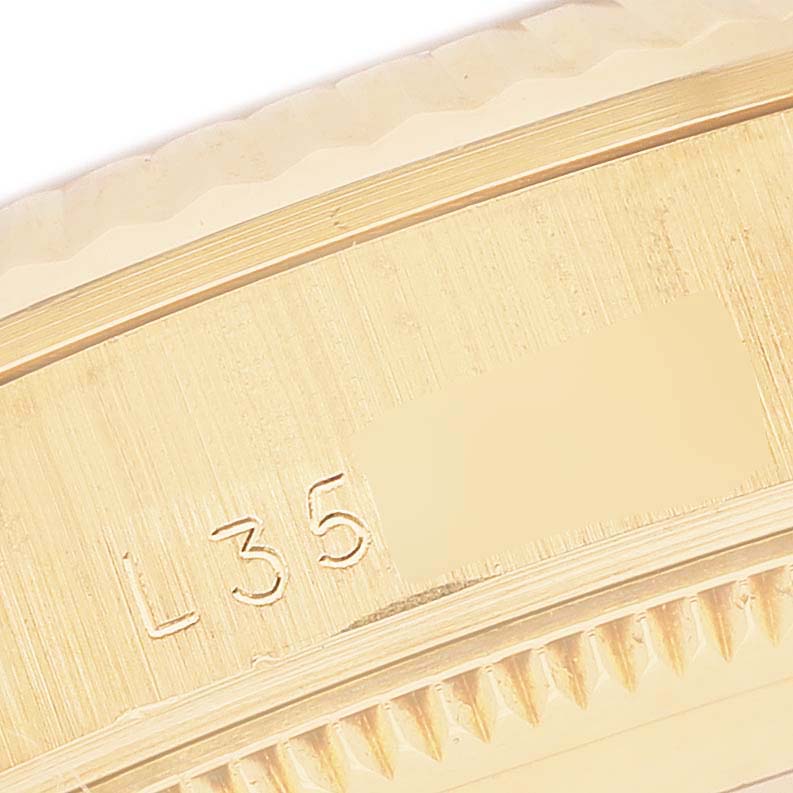 The image shows a close-up of the side edge of a Rolex President 68278 Women's Yellow Gold Black Dial model, highlighting the engraving and part of the bezel.