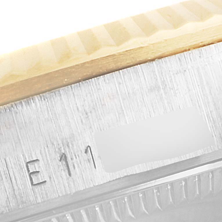 This image shows a close-up view of the bezel and part of the rehaut with engravings of a Rolex President 68279 Women's White Gold Brown Dial 68279 Women's White Gold Brown Dial model watch.