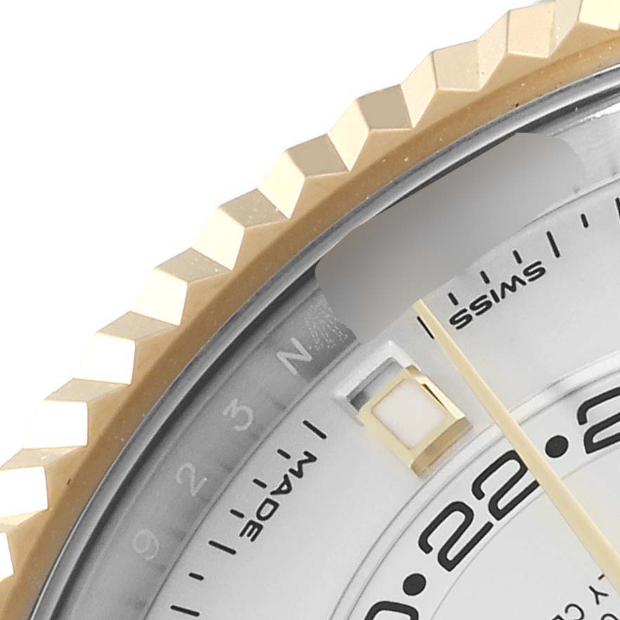 This image shows a close-up of the bezel and part of the dial of a Rolex Sky-Dweller 326933 Men's Steel and Gold (two tone) White Dial 326933 Men's Steel and Gold (two tone) White Dial watch.