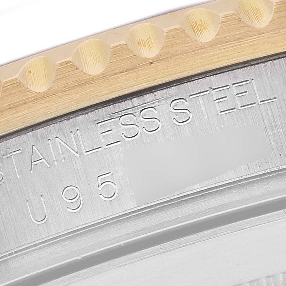 The image shows a close-up of the edge and part of the bezel with "STAINLESS STEEL" engraved on the Rolex Submariner 16613 Men's Steel and Gold (two tone) Blue Dial 16613 Men's Steel and Gold (two tone) Blue Dial watch.