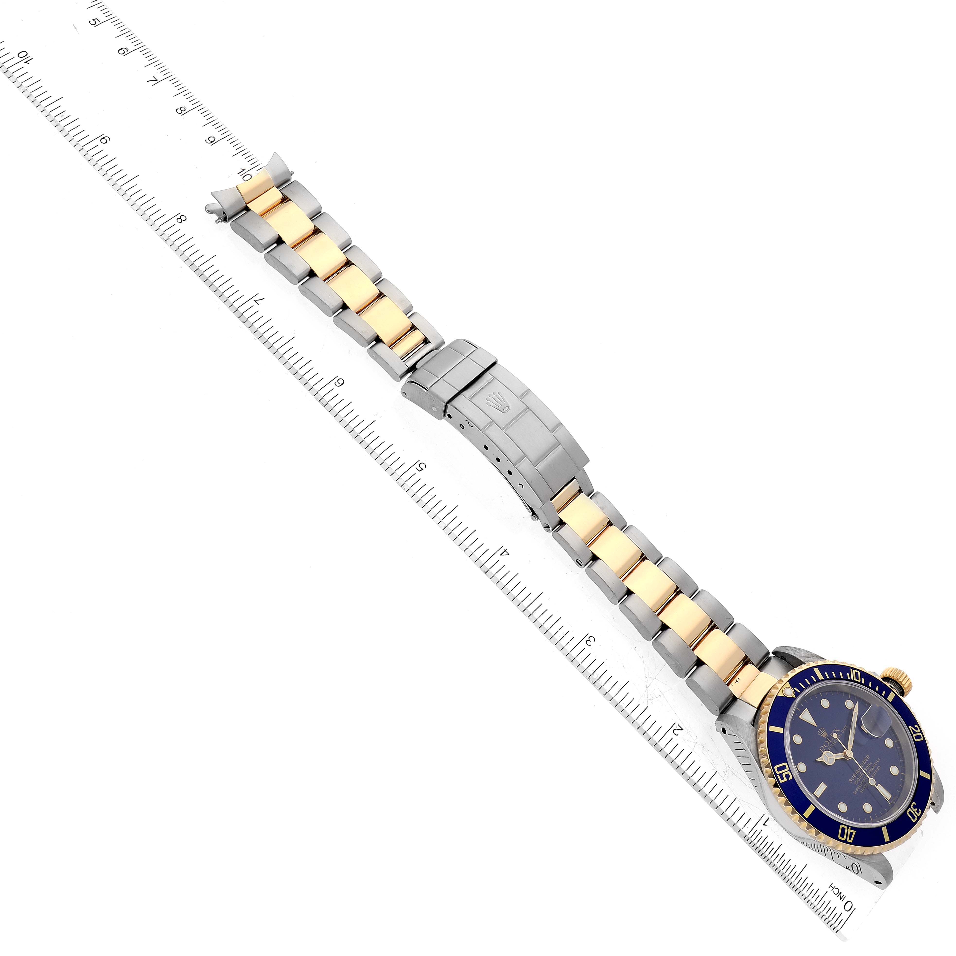 The image shows a top-down view of the Rolex Submariner 16613 Men's Steel and Gold (two tone) Blue Dial 16613 Men's Steel and Gold (two tone) Blue Dial watch, highlighting the face, bezel, and two-tone bracelet.