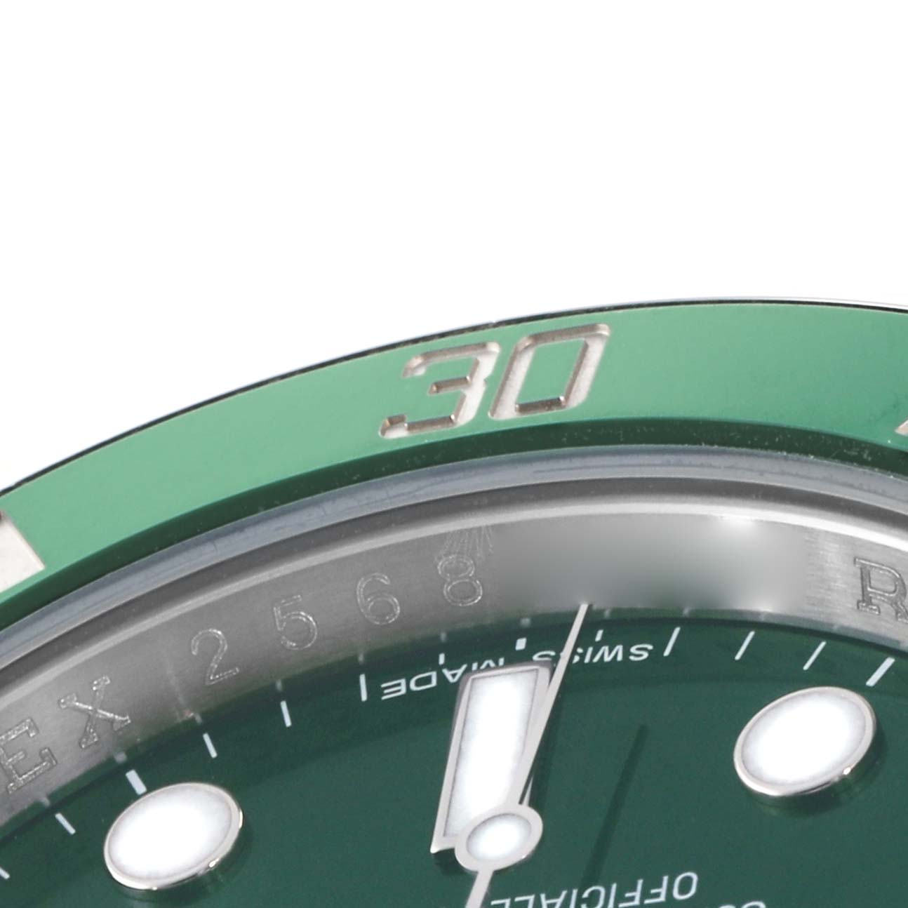 The image shows a close-up of the green bezel, dial, and minute hand of a Rolex Submariner 116610LV Men's Stainless Steel Green Dial watch.