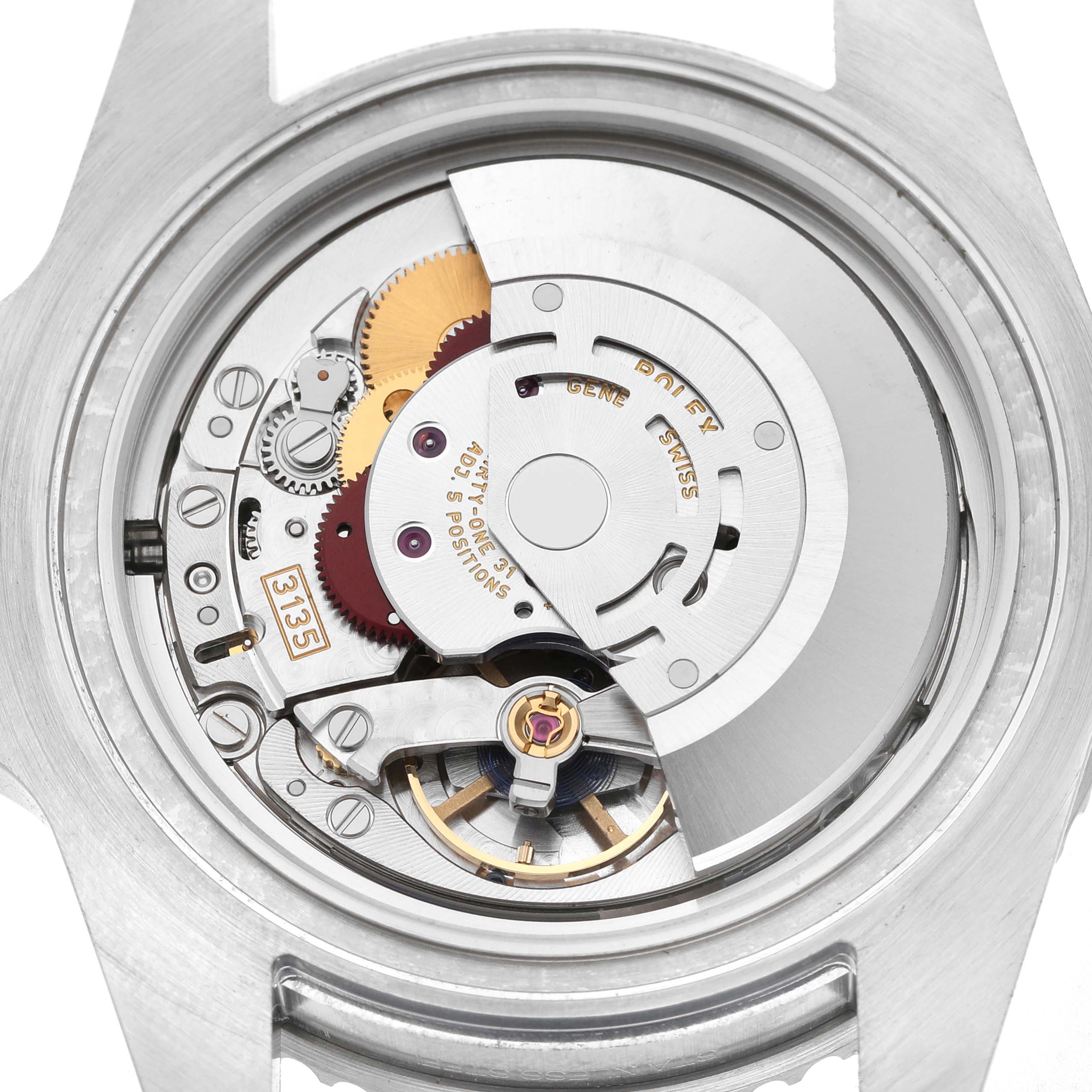 The image shows the movement mechanism of a Rolex Submariner 116610LV Men's Stainless Steel Green Dial watch from a rear angle, detailing the intricate gears and components.